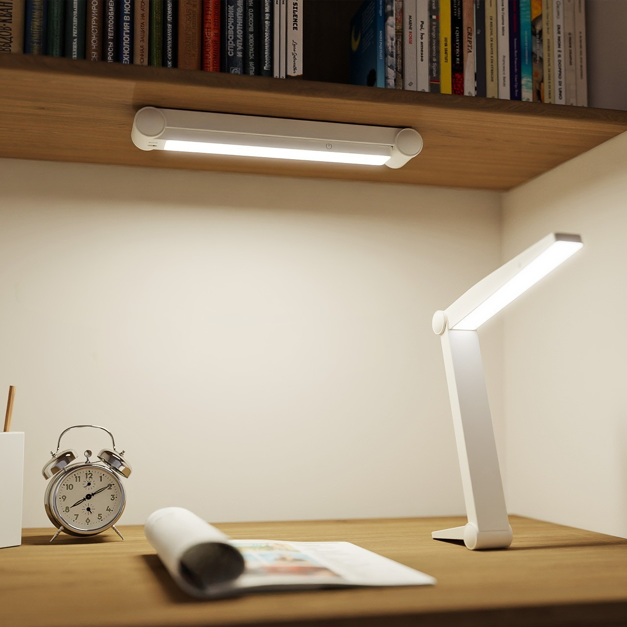 Eine weiße Schreibtischlampe und eine Regalleuchte werden über einem Schreibtisch mit Gegenständen gezeigt.