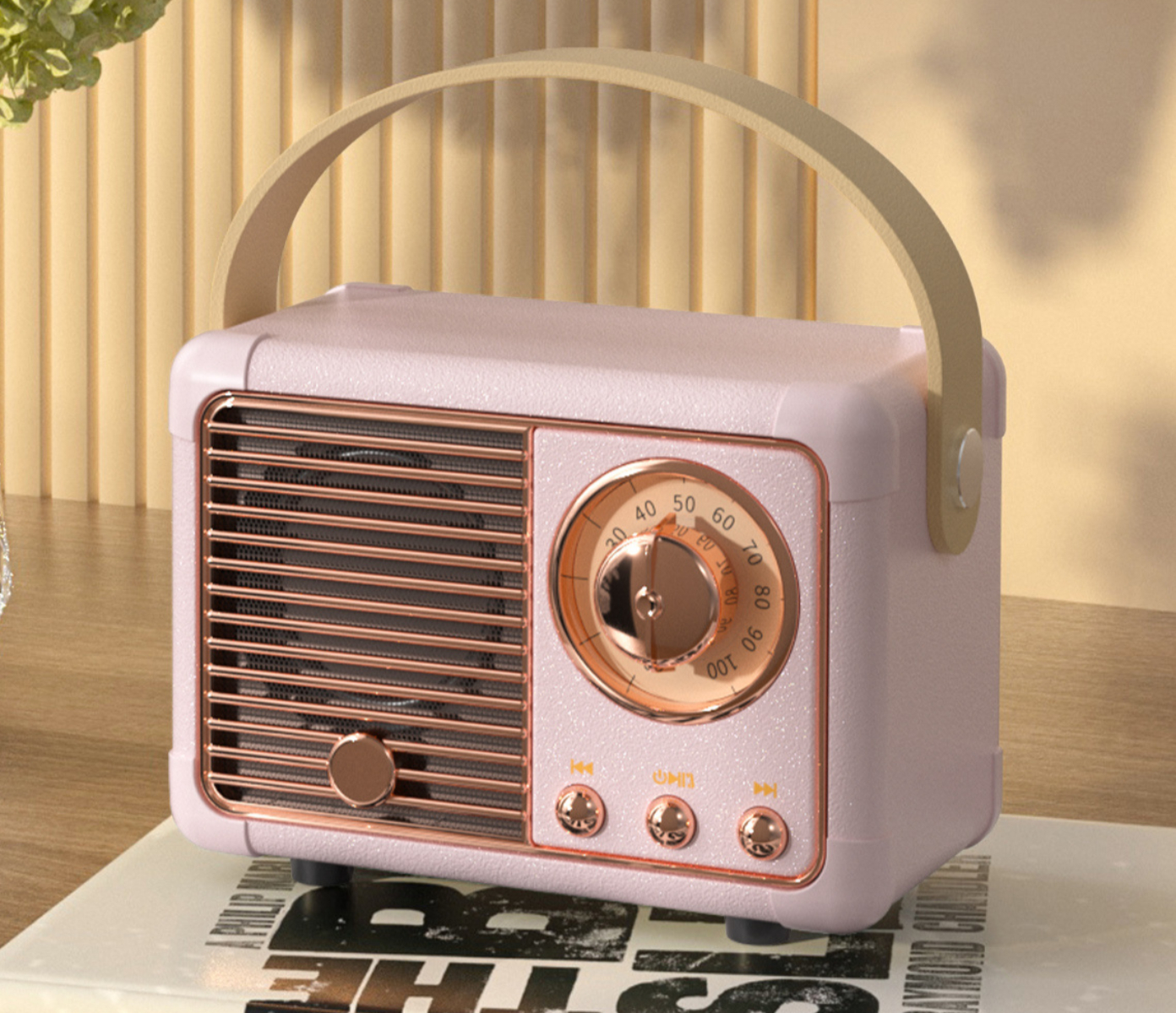 Rosa Retro-Radio mit Griff, rundem Zifferblatt und Knöpfen. Auf einer Oberfläche mit Text platziert.