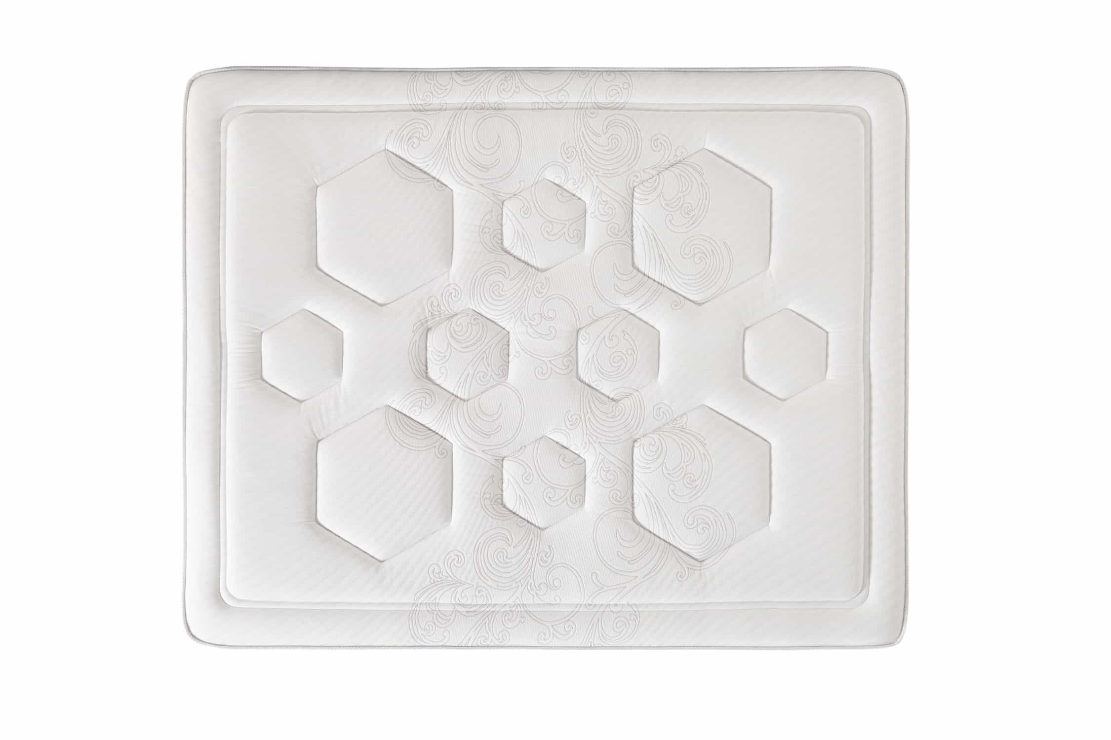 Fehér matrac méhsejtmintával és geometriai formákkal.