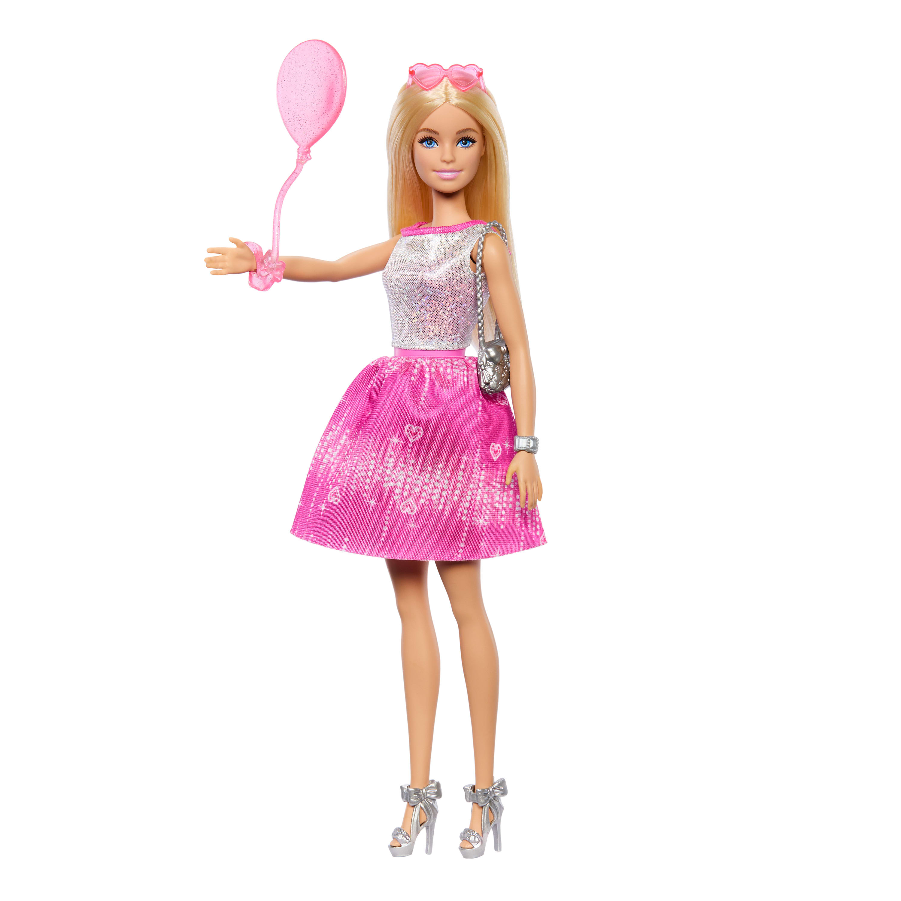 Muñeca Barbie rubia sosteniendo un globo rosa, con top plateado y falda rosa. Fondo blanco.