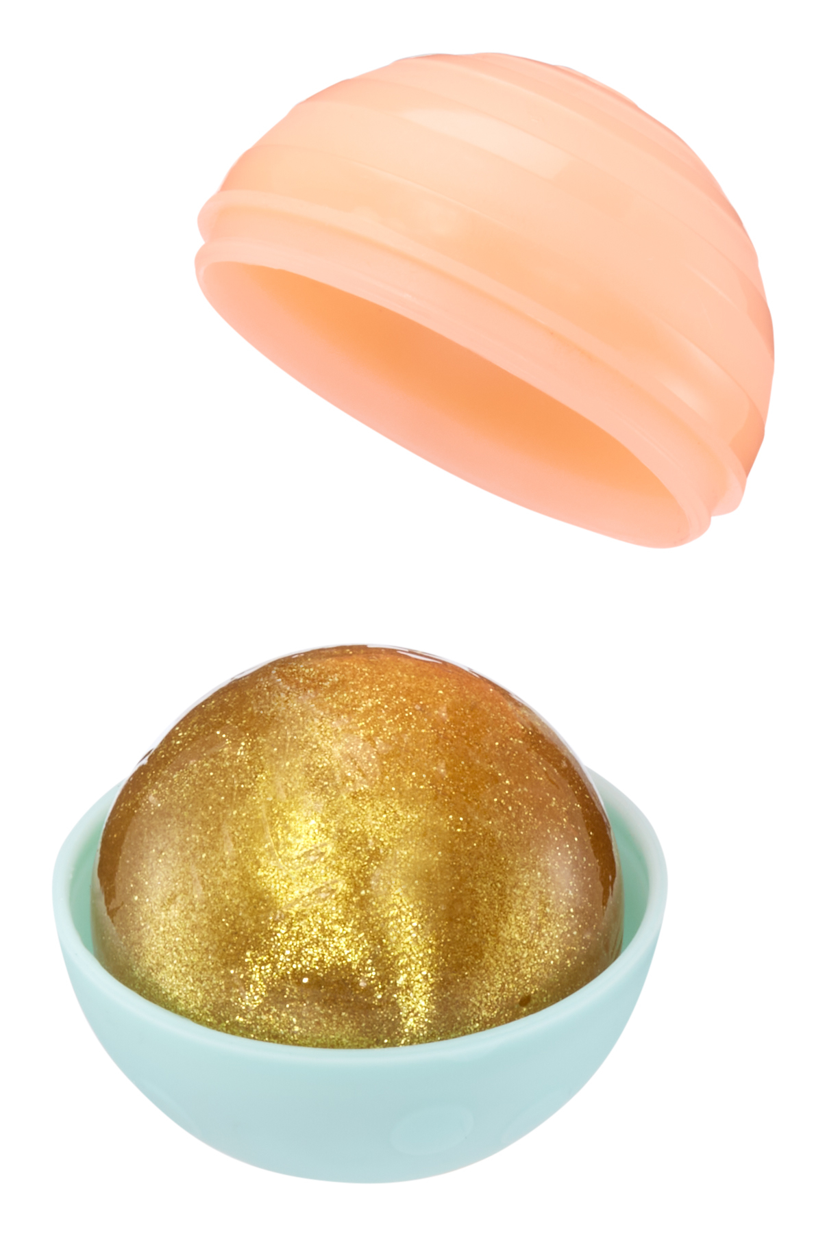 Pojemnik w kształcie jaja ze złotą, błyszczącą substancją w niebieskiej misce.