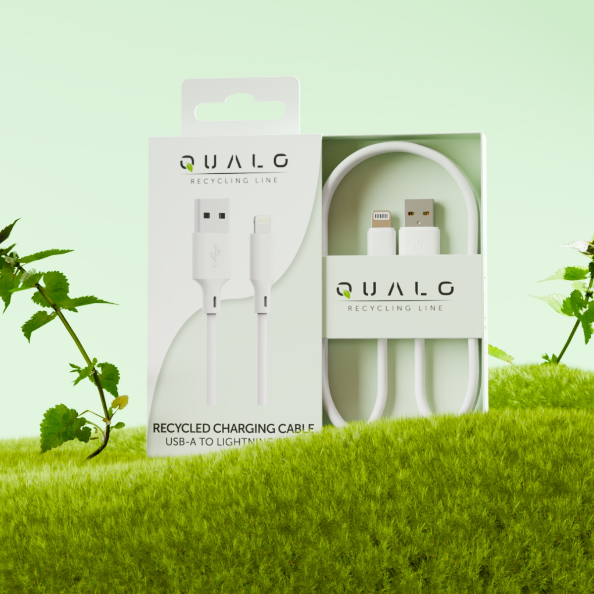 Biały kabel USB-A do Lightning w pudełku, zielone tło z trawą i roślinami.