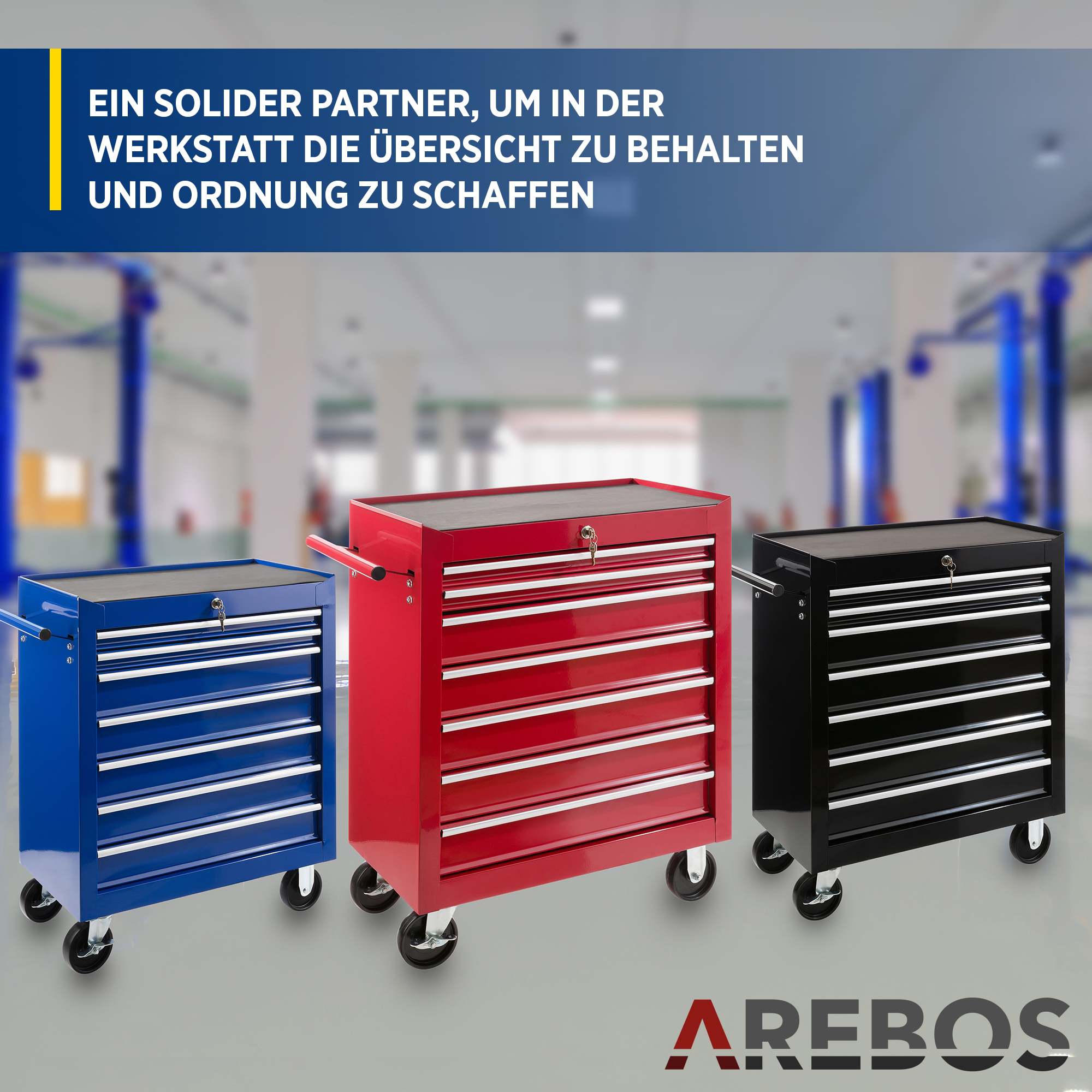 Drei rollende Werkzeugschränke, blau, rot und schwarz, in einer Werkstatt.