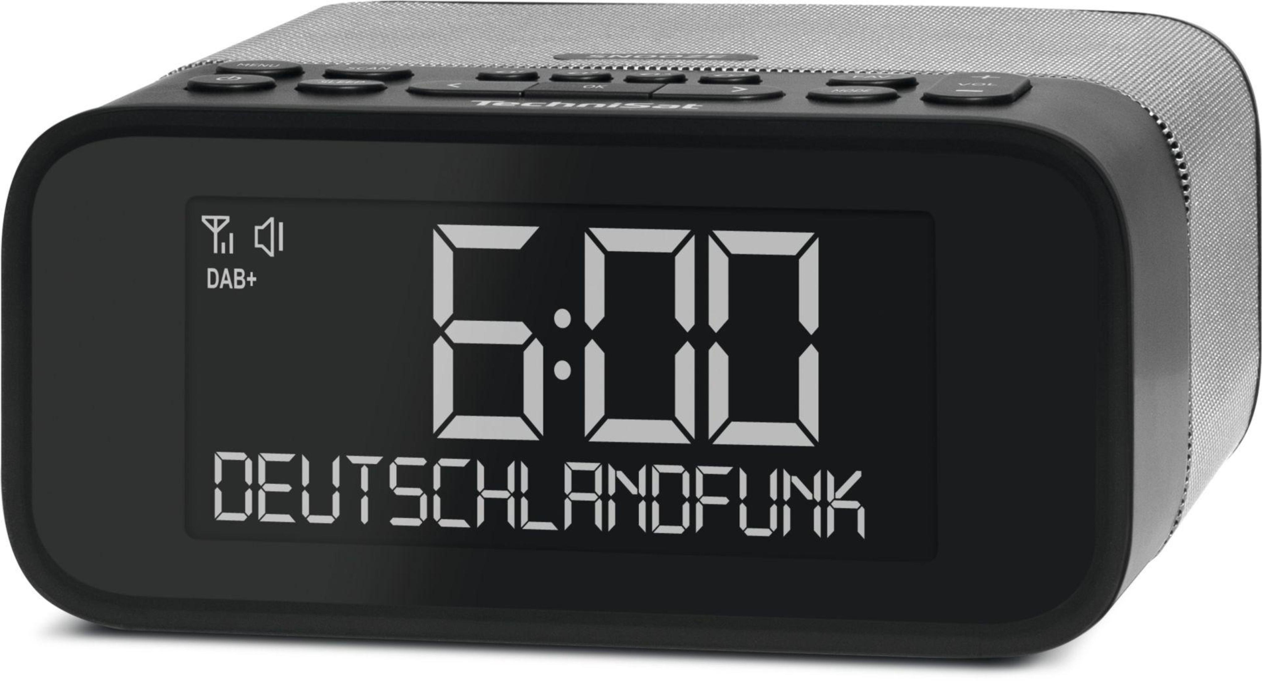 Schwarzer digitaler Wecker mit der Anzeige 6:00. Der Bildschirm zeigt „DEUTSCHLANDFUNK“ an.
