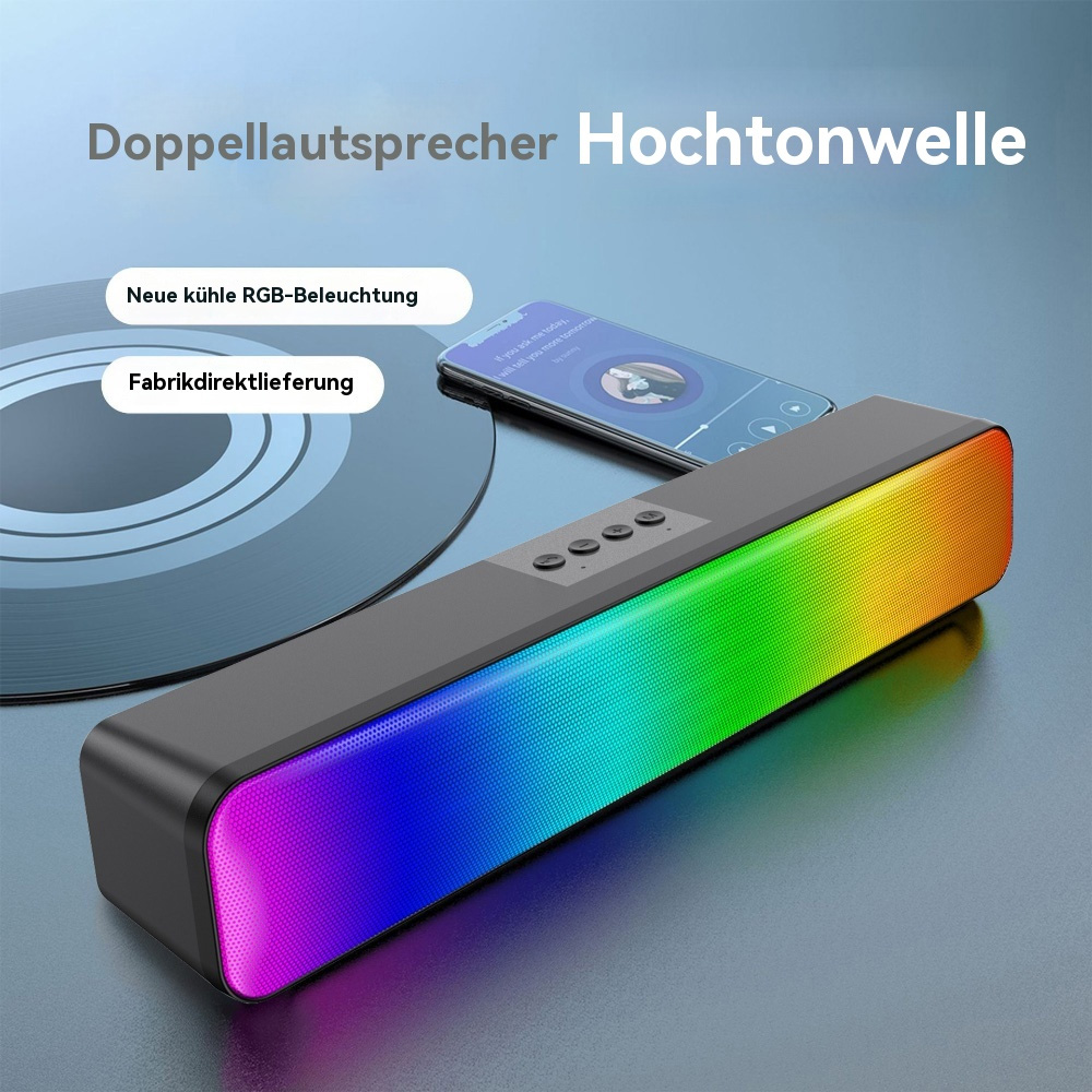 Schwarze Soundbar mit farbigen Lichtern. Ein Telefon und eine Schallplatte sind ebenfalls sichtbar.