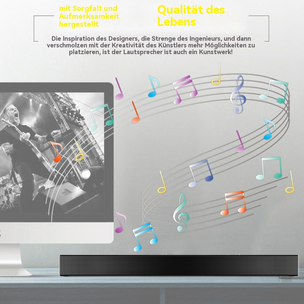 Eine Soundbar unter einem Computermonitor mit Noten. Der Hintergrund ist unscharf.
