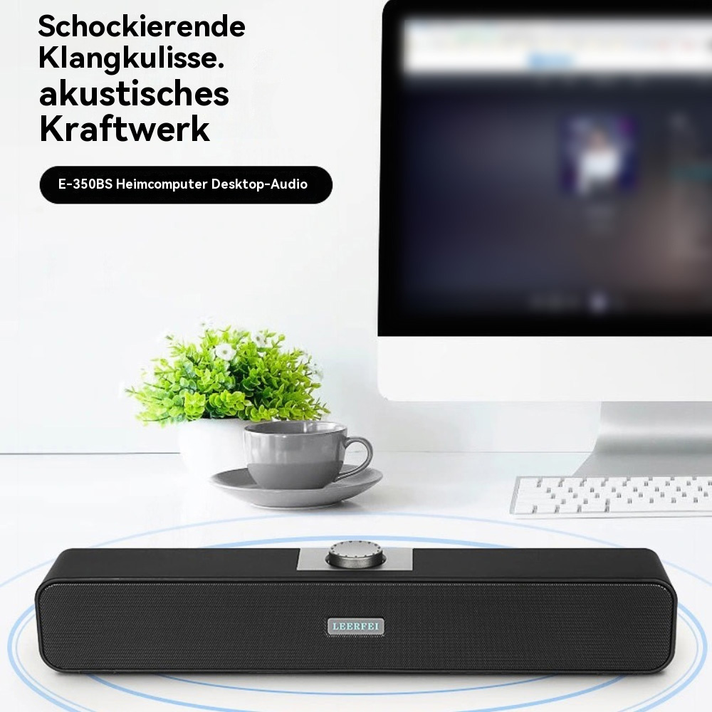 Schwarze Soundbar auf einem weißen Schreibtisch mit Tasse und Pflanze. Text: 'Schockierende Klangkulisse.'