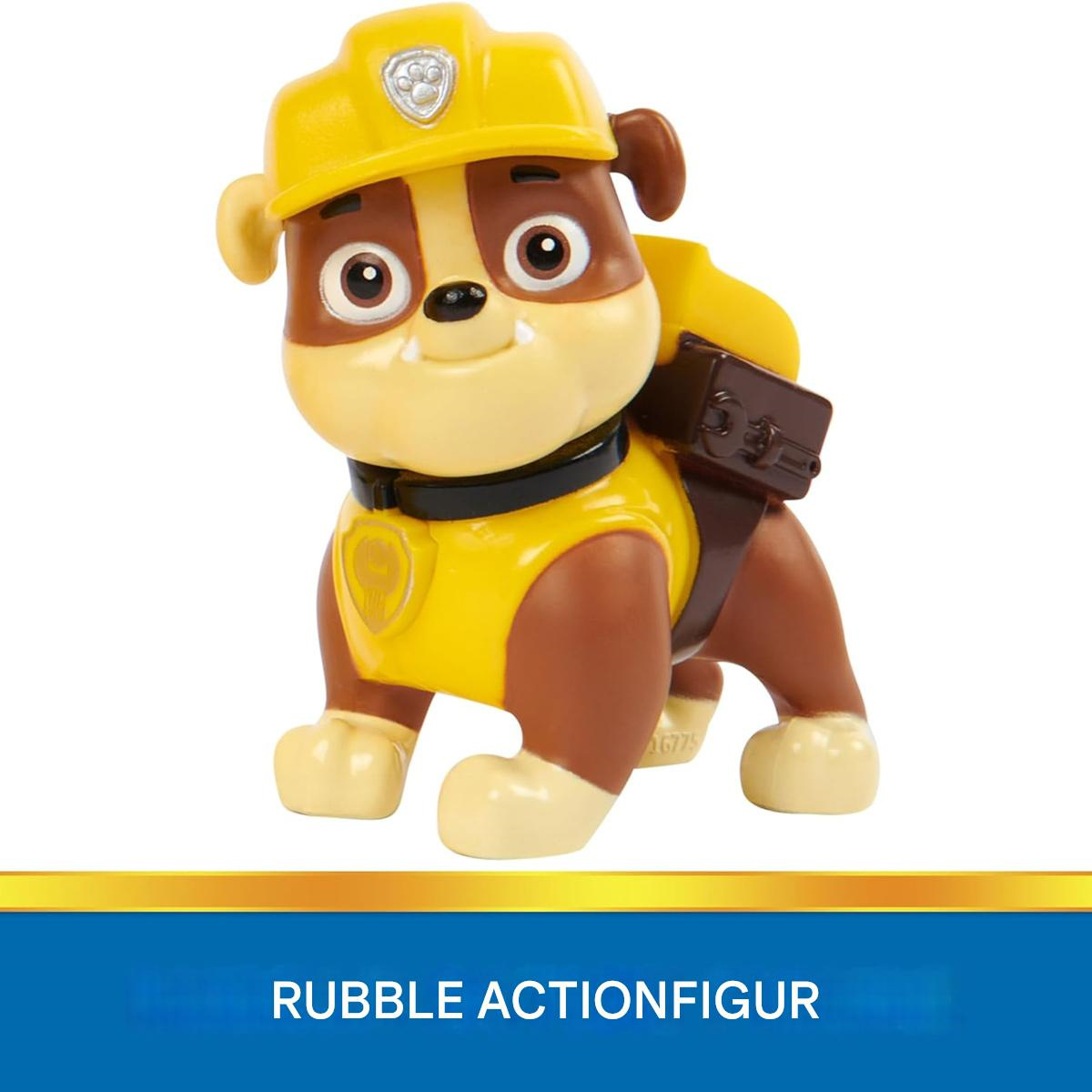 Eine Rubble-Actionfigur. Der Hund ist braun und gelb und trägt einen gelben Helm und eine Weste.