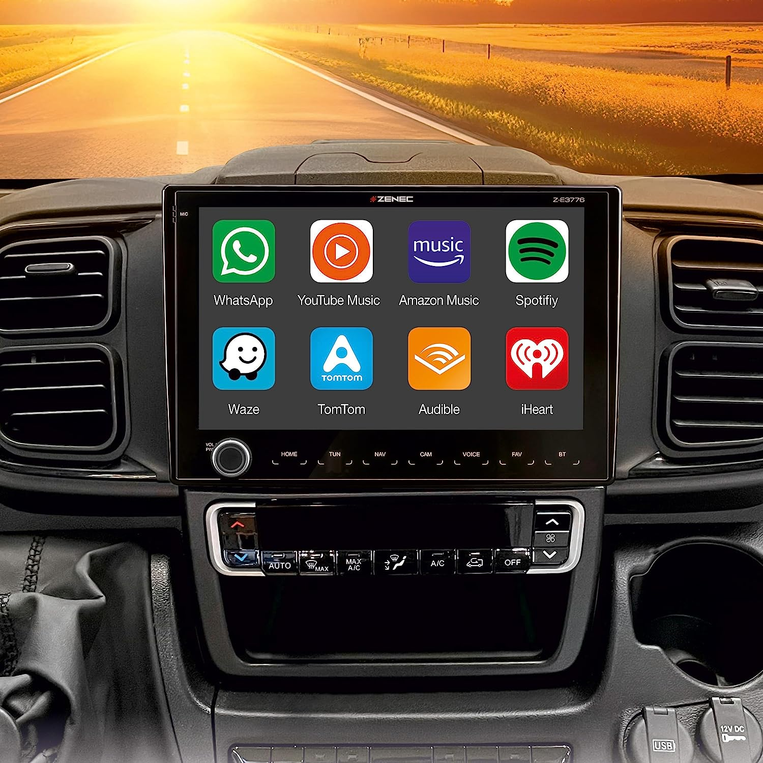 Bildschirm eines Car-Multimedia-Systems, der App-Symbole auf einem Armaturenbrett mit Sonnenlicht im Hintergrund anzeigt.