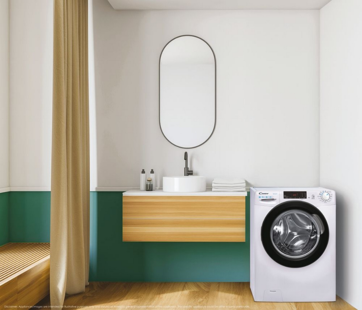 Una lavatrice bianca in un ambiente bagno. Uno specchio, lavandino e mobile sono anch'essi nella scena.