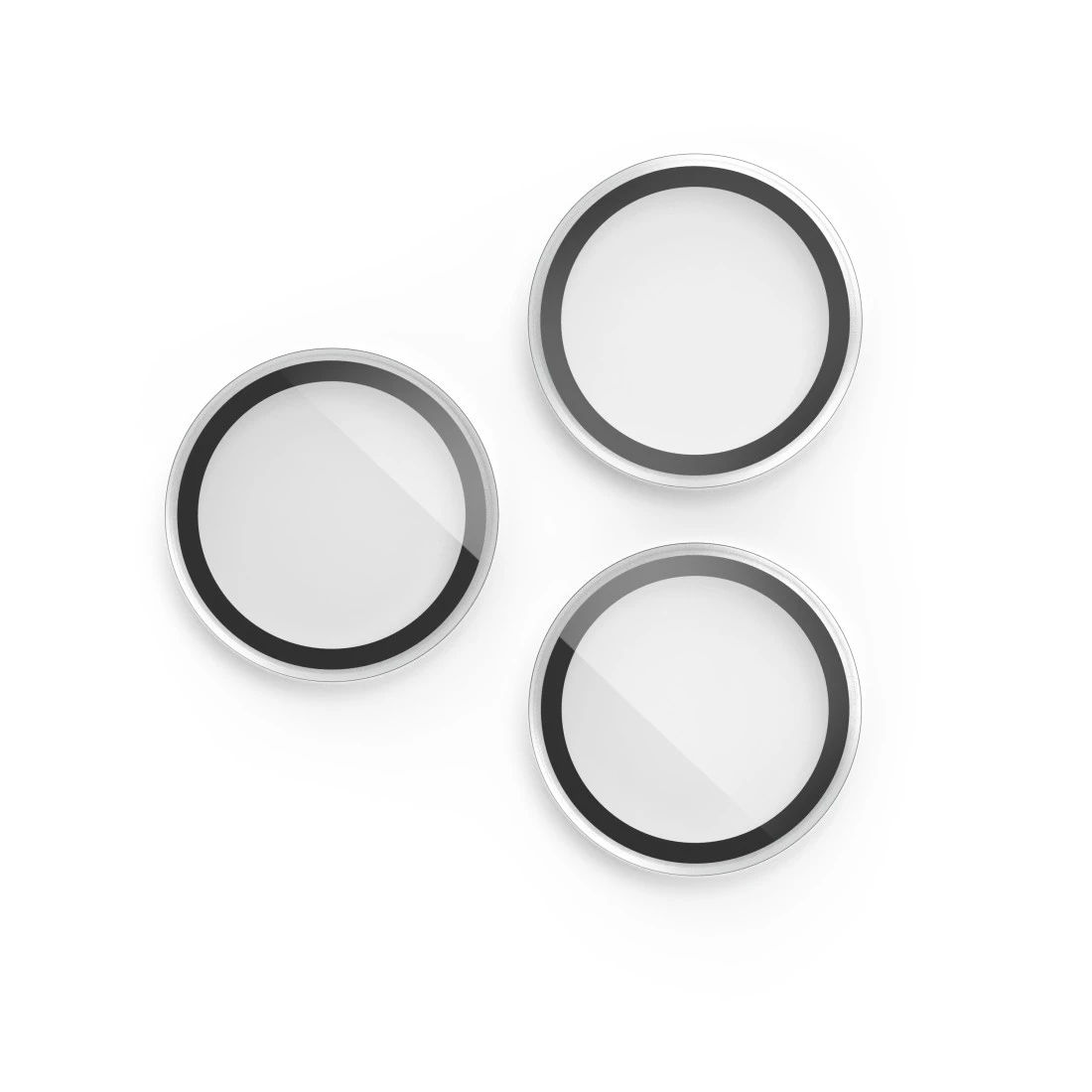 Tre protezioni per lenti della fotocamera rotonde con anelli neri e centri bianchi.