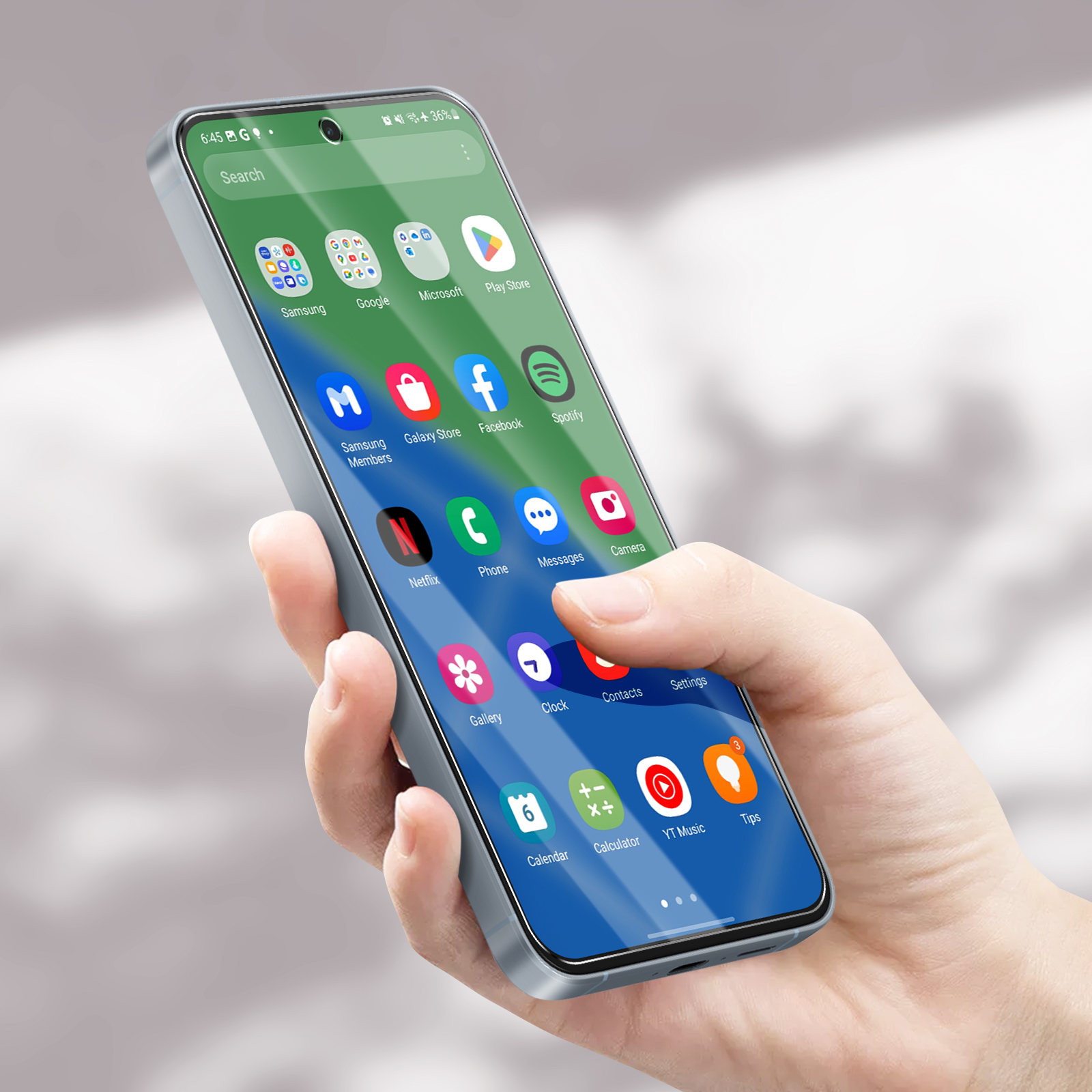 Una persona che tiene un telefono che mostra uno schermo di app. Il telefono ha una custodia argentata, con app sullo schermo.