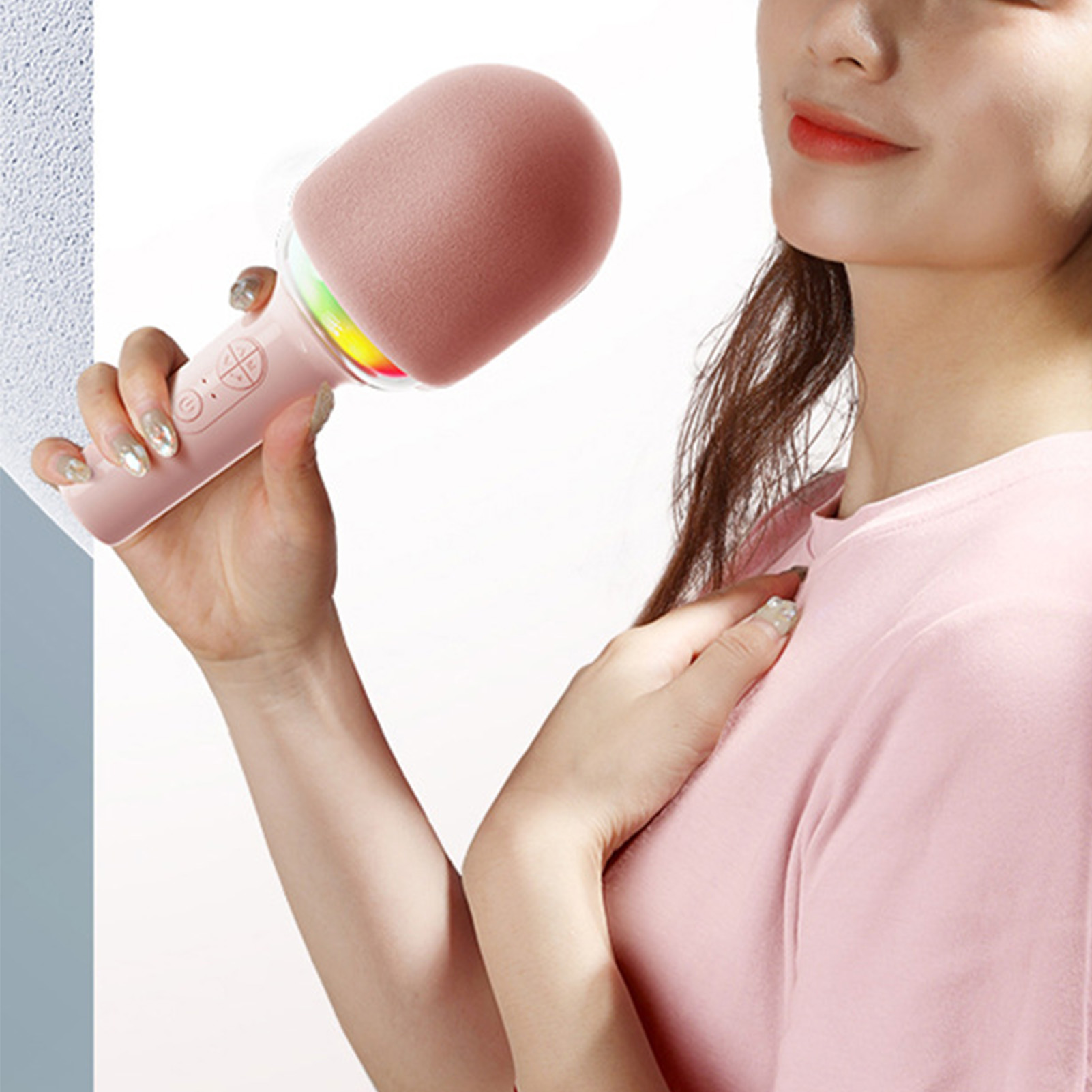 Person hält ein rosa Mikrofon mit Regenbogenlichtern. Rosa Hemd. Weißer Hintergrund.