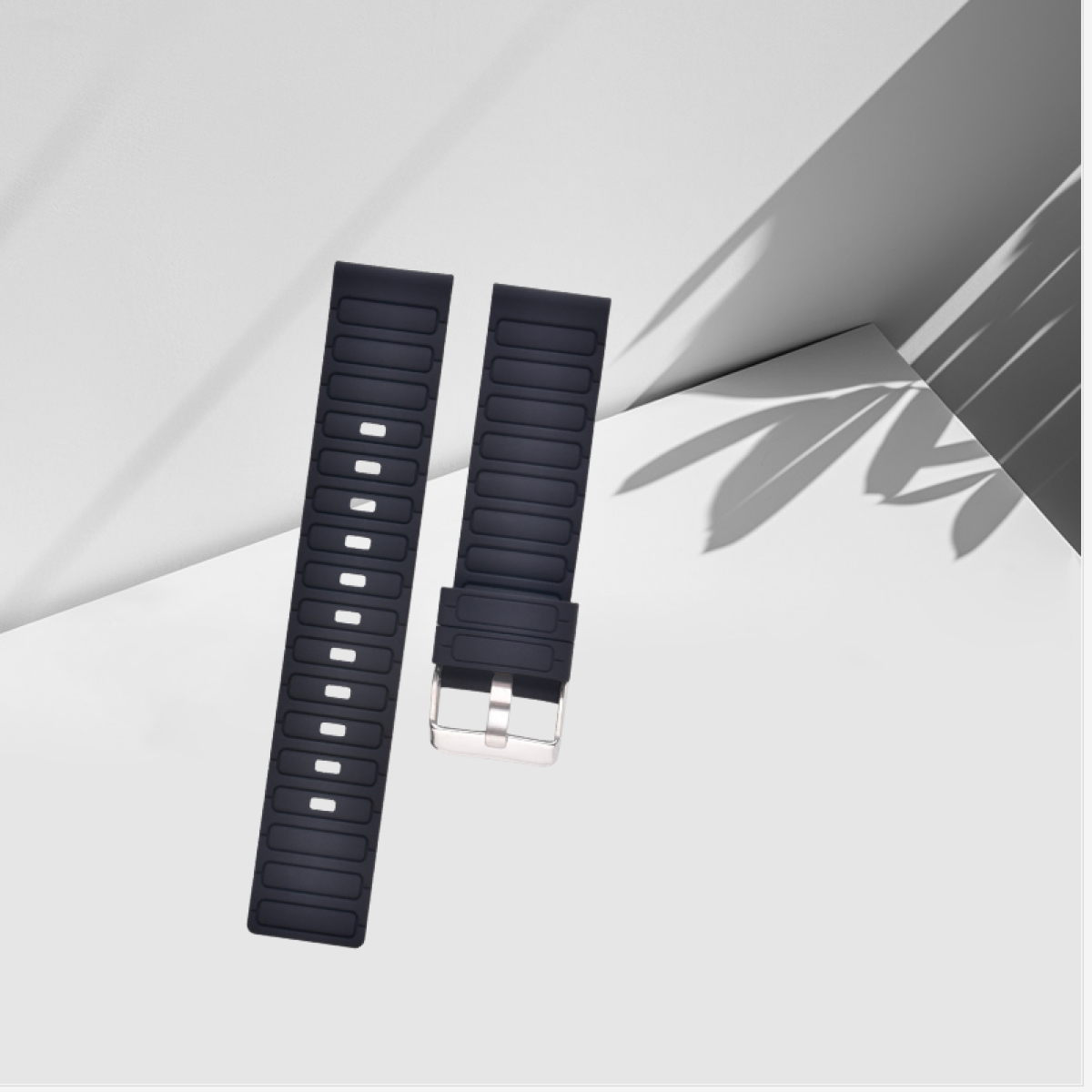 Zwei schwarze Uhrenarmbänder mit weißen Löchern und Metallschnalle. Weißer Hintergrund.