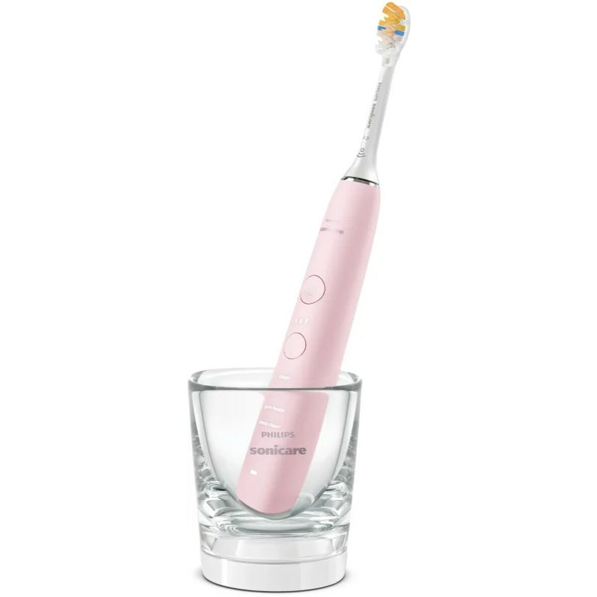 Spazzolino elettrico rosa in un bicchiere trasparente, sfondo bianco.