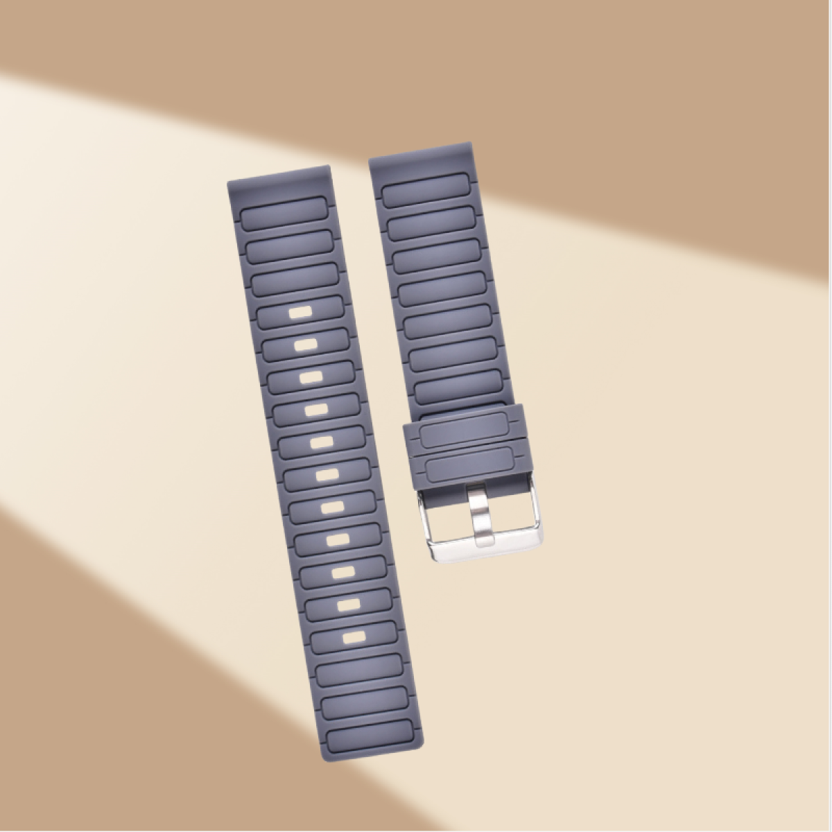 Zwei graue Uhrenarmbänder mit Metallschnallen auf beigem Hintergrund.