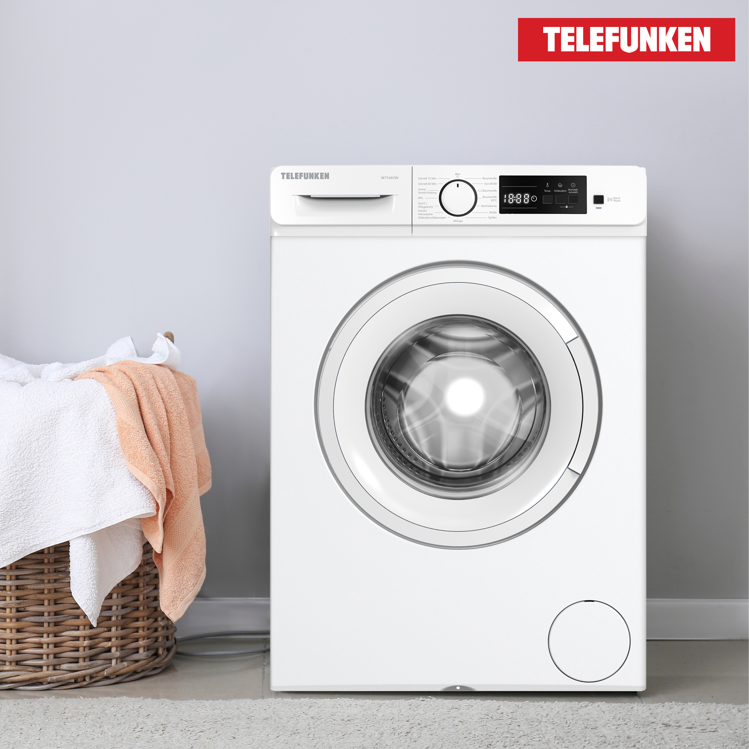 Weiße Telefunken Waschmaschine. Korb mit Handtüchern links. Rotes Telefunken Logo oben.