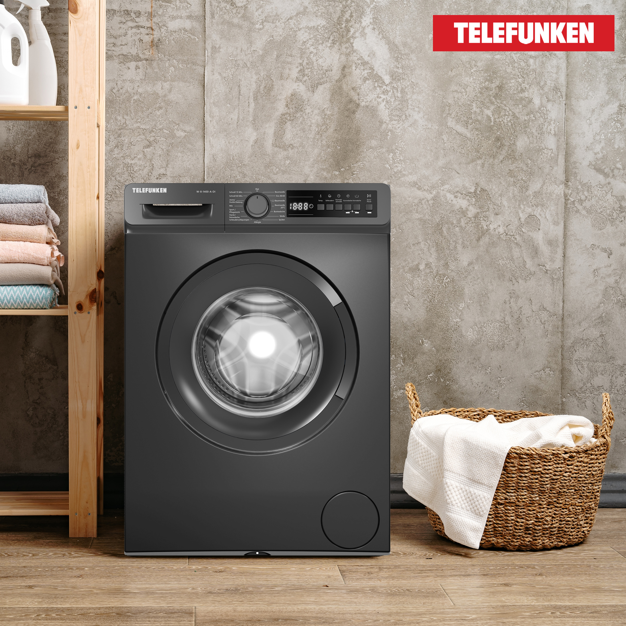 Dunkelgraue Telefunken Waschmaschine. Korb mit Handtüchern rechts. Rotes Telefunken Logo.