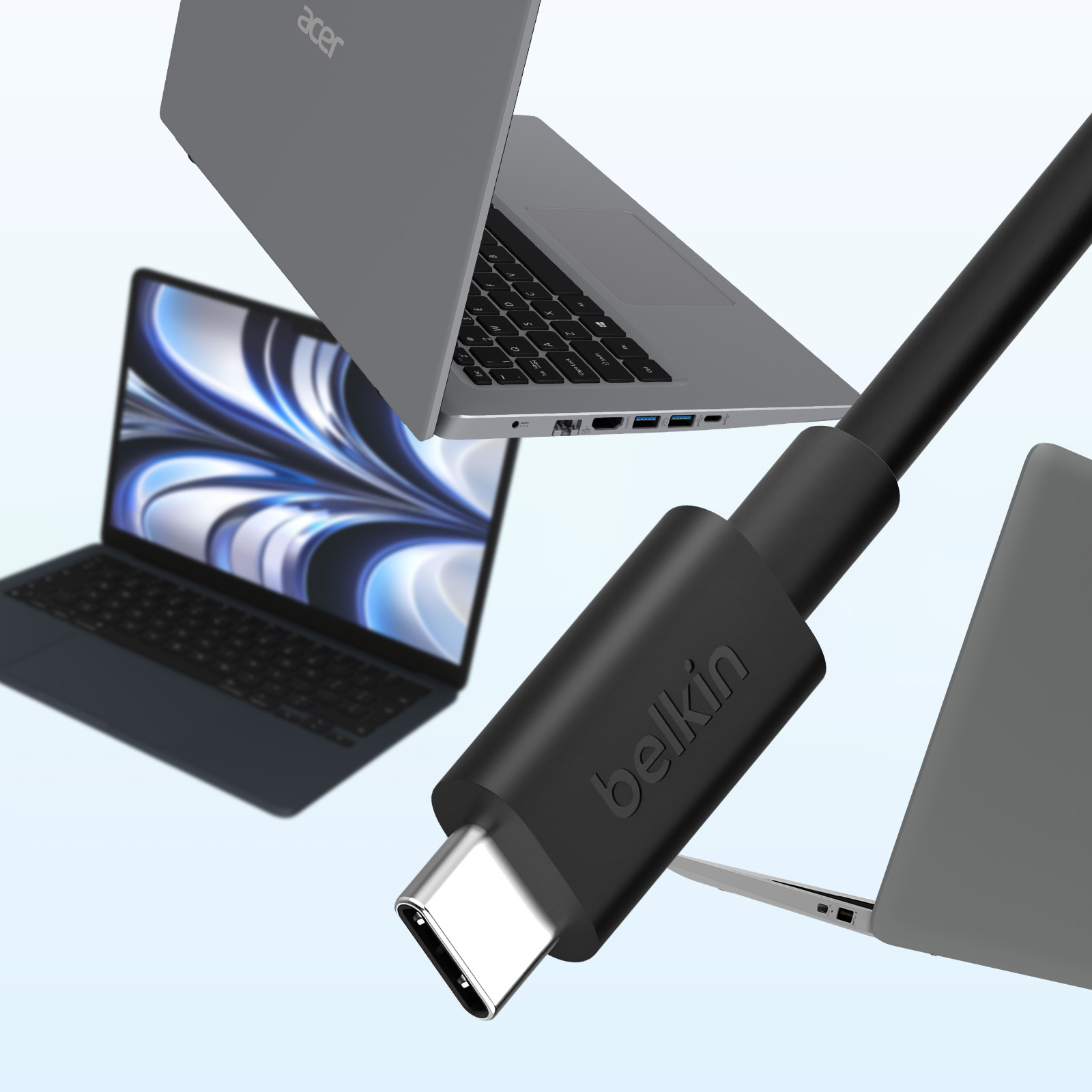 Laptop e un cavo USB-C Belkin. I laptop sono grigi e neri. Il cavo è nero con etichetta Belkin.