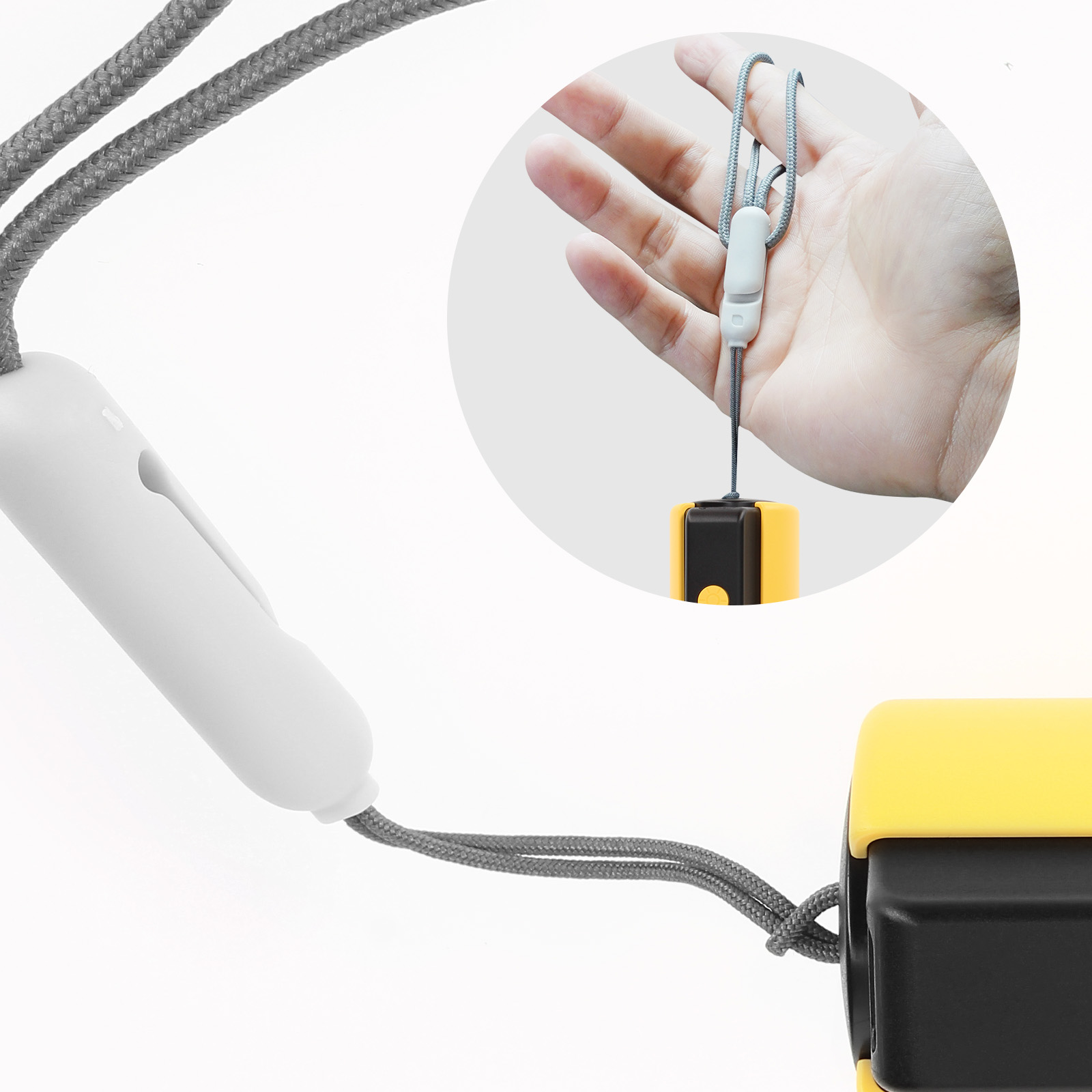Vista de primer plano de un cordón con un pequeño artículo amarillo y negro adjunto a un deslizador blanco.