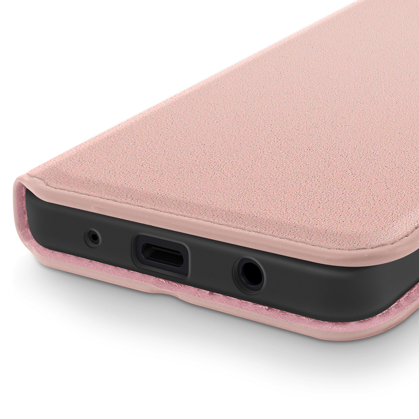 Primo piano del bordo inferiore di una custodia per telefono, rosa polveroso, con porta e jack audio.