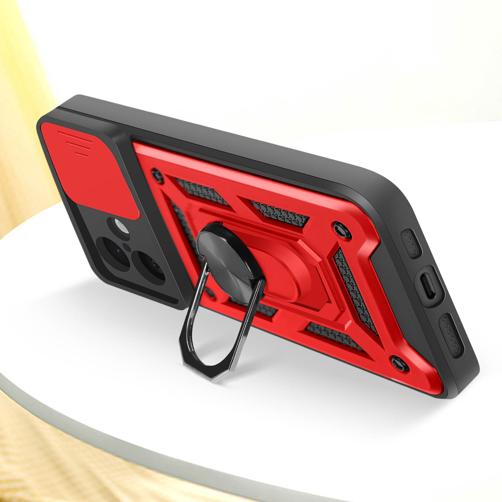 Custodia rossa e nera per telefono con supporto ad anello e copertura della fotocamera. Lo sfondo è sfocato.