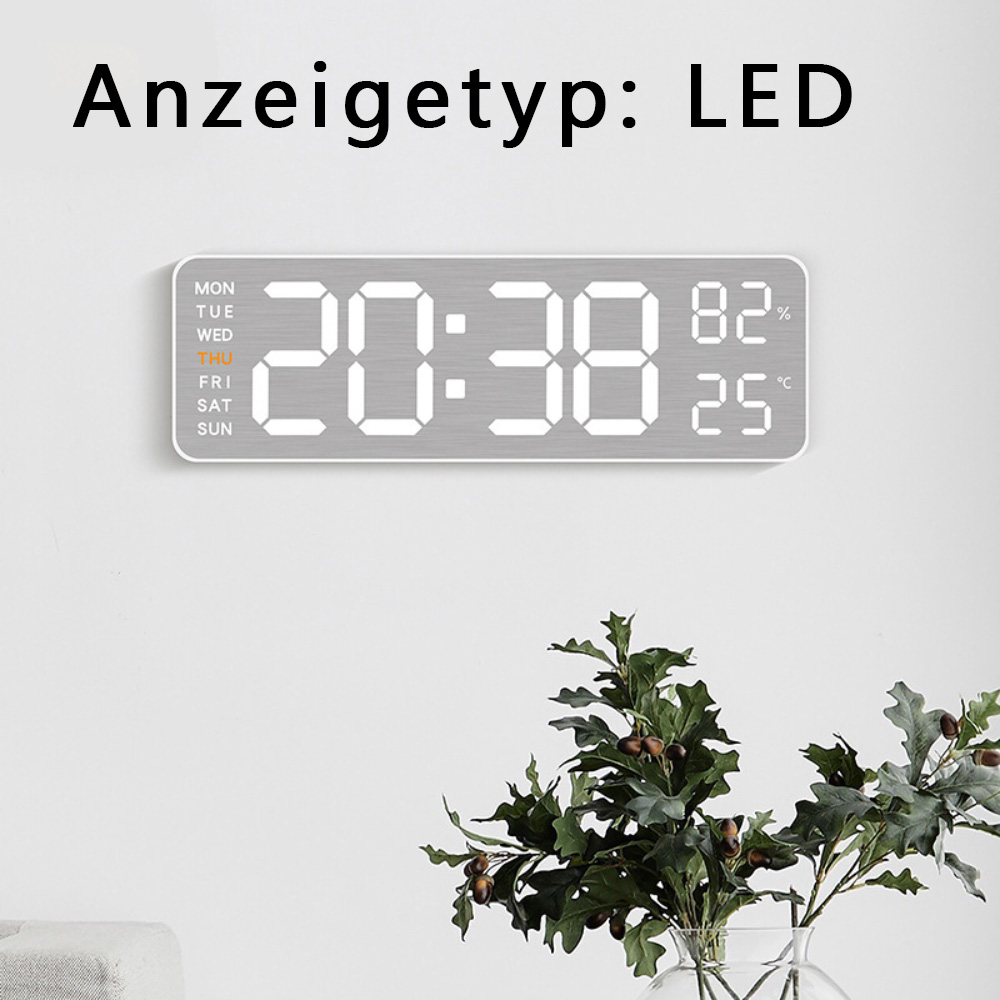 Digitaluhr zeigt 20:38, 82% und 25°C. Blätter in Vase im Vordergrund.