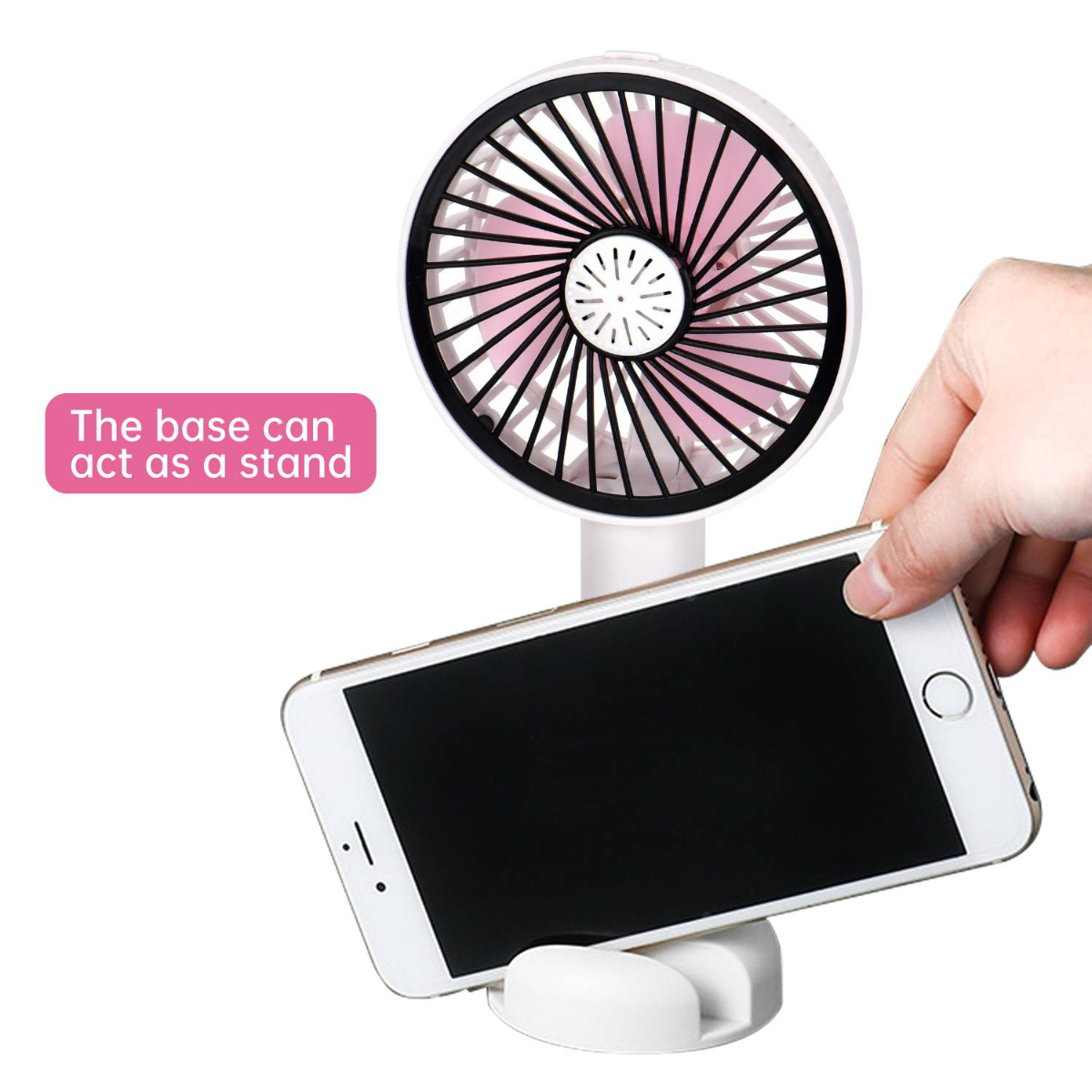 Weißer Ventilator mit rosa Flügeln, der ein Smartphone hält. Die Basis dient als Ständer.