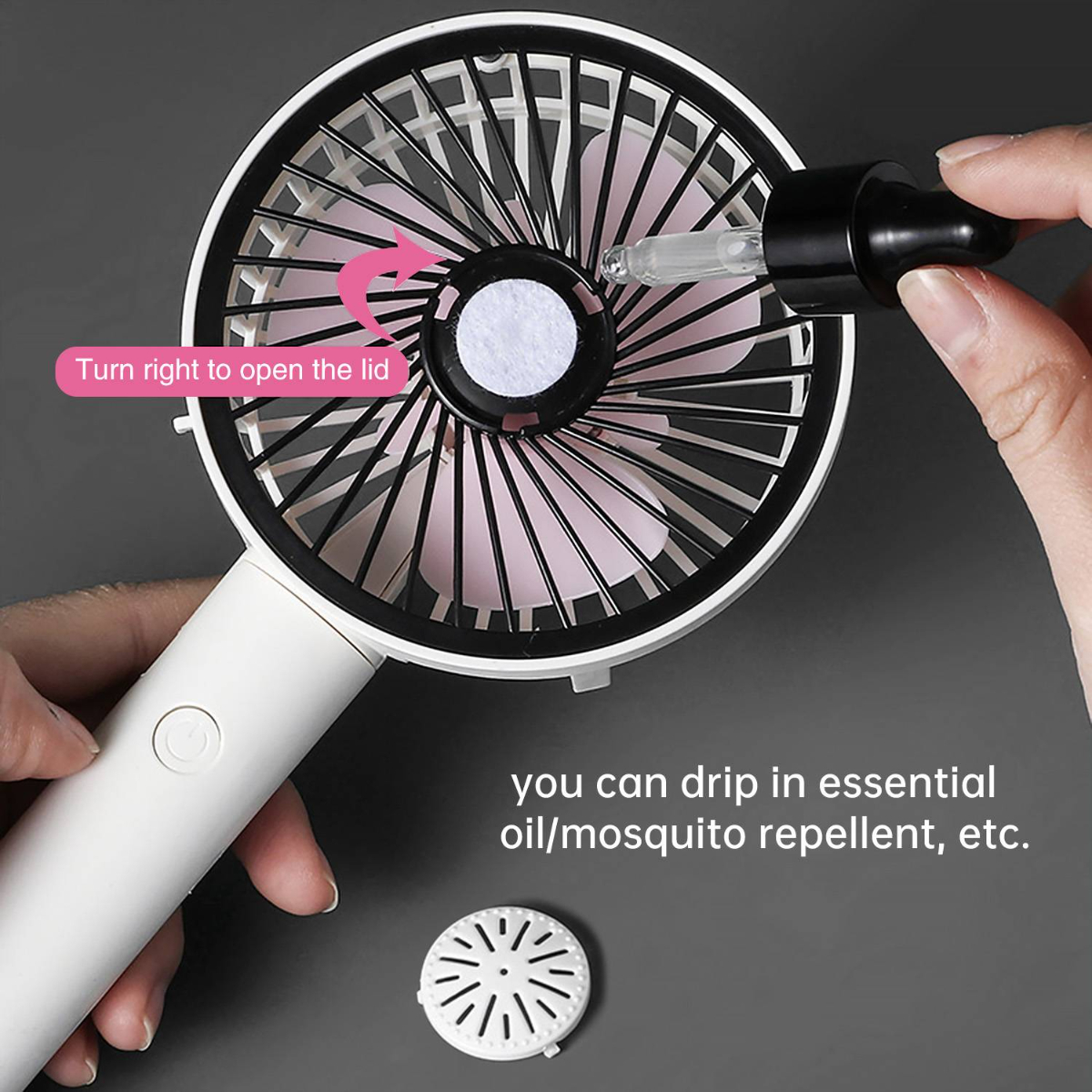 Handventilator mit rosa Flügeln. Ätherisches Öl wird in den Ventilator getropft.