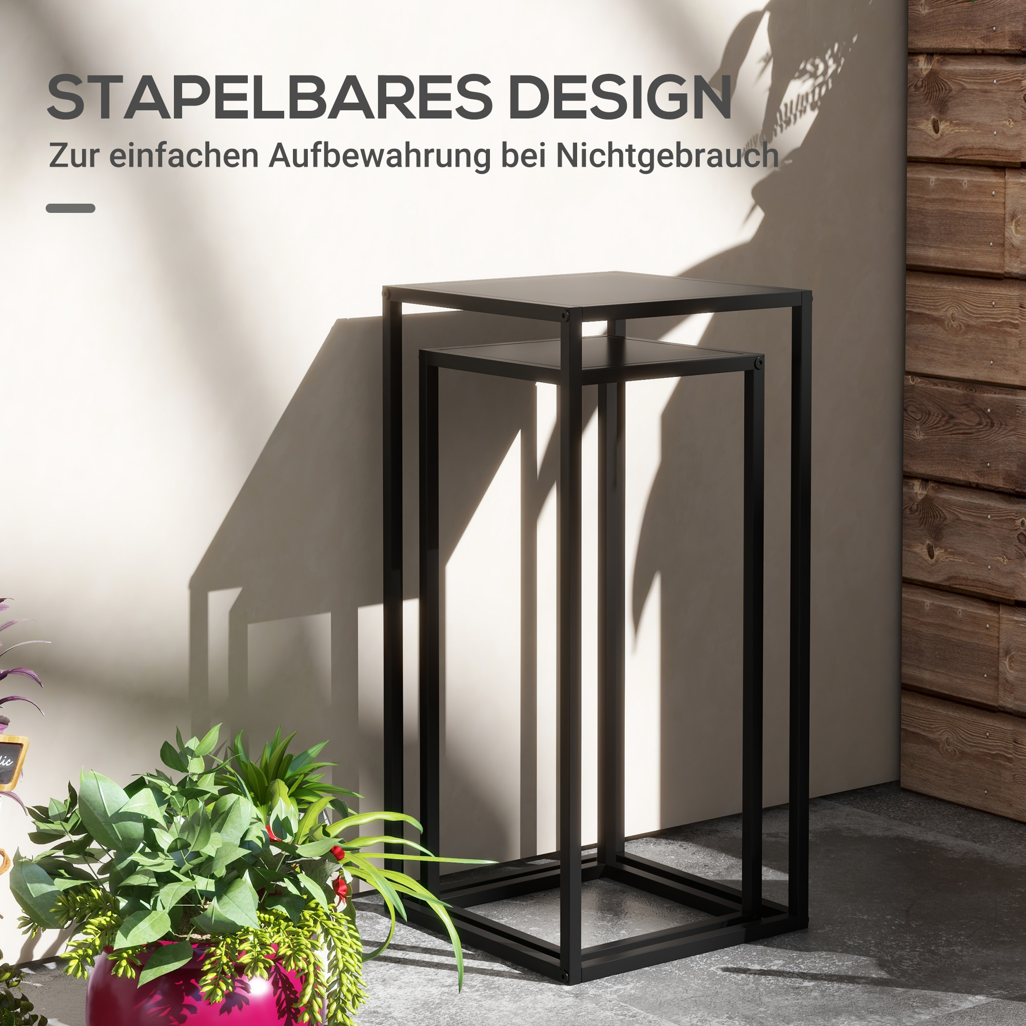 Zwei schwarze, gestapelte Tische. Text: 'stapelbares Design'.