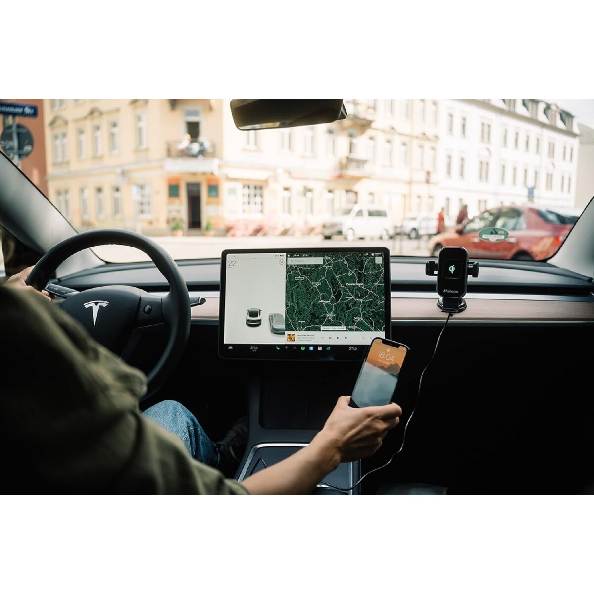 Persona usando un teléfono en un coche, con soporte y pantalla de mapa.