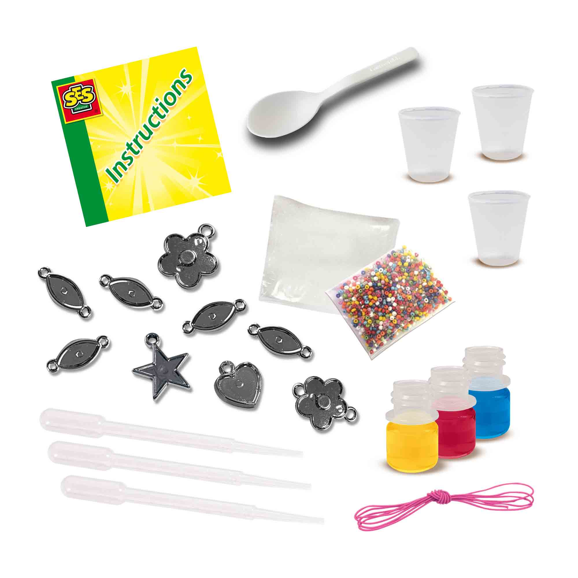 Set di artigianato: istruzioni, cucchiaio, tazze, perline, ciondoli e piccole bottiglie con liquido colorato.