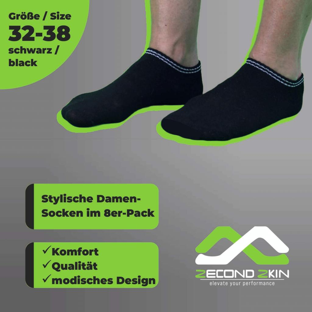 Zwei schwarze Socken, mit deutschem Text. Die Socken haben einen grünen und weißen Streifen.