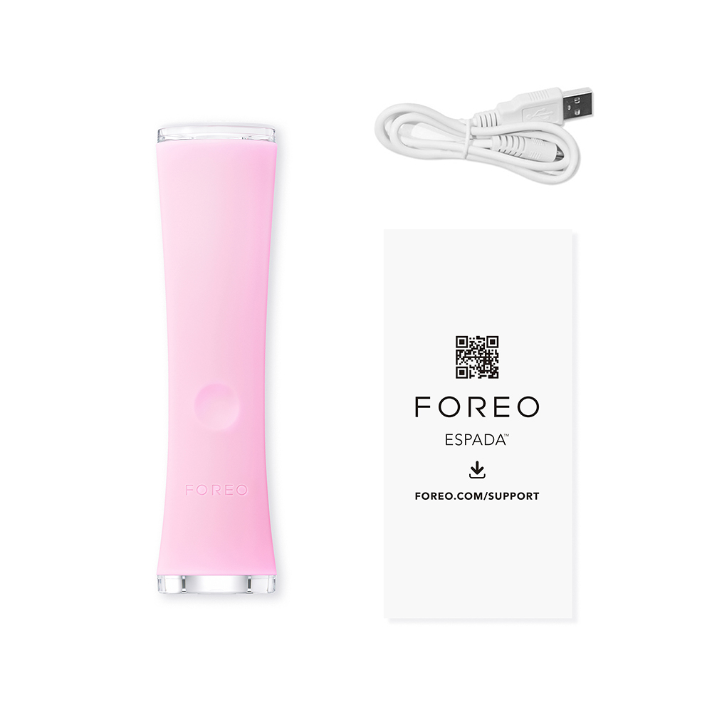 Pink Foreo Espada 2 with USB cable and support card, on a white background.