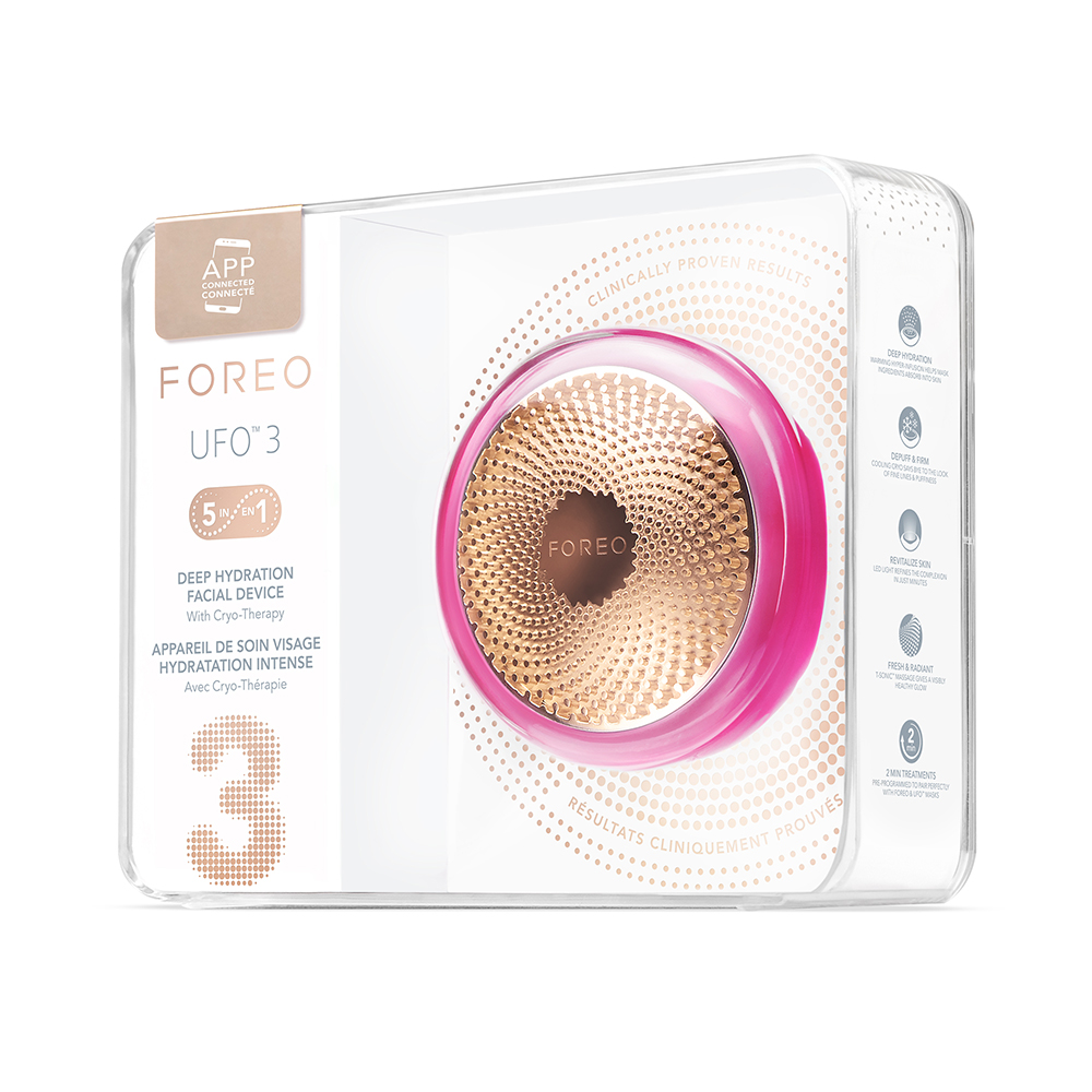 A Foreo UFO 3 device in a clear box. The device is pink and gold.