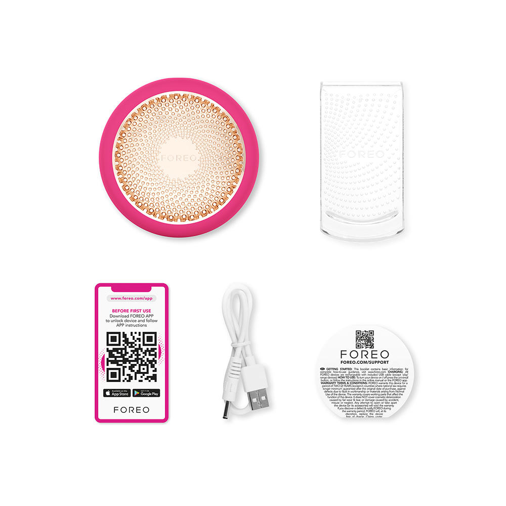 Pink and gold face cleanser, charging stand, QR code card, and USB cable.