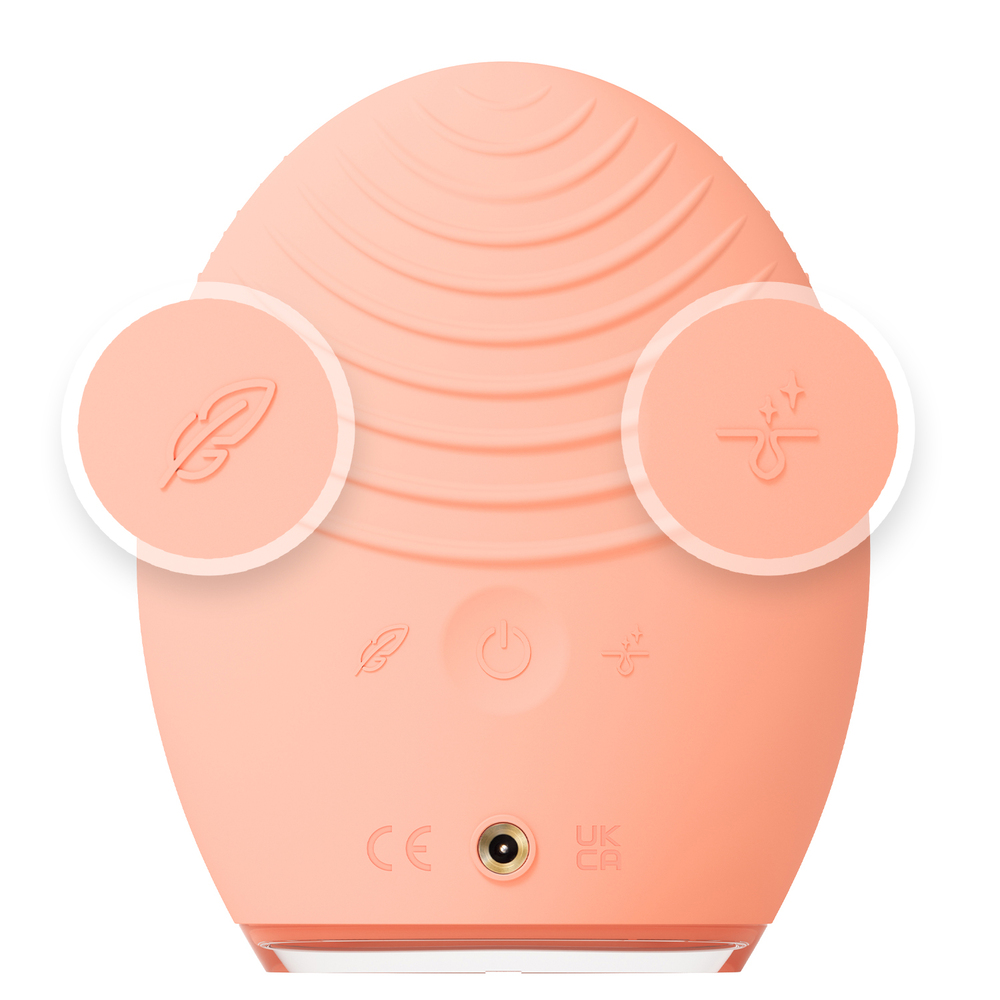 A pink Foreo device with icons. The device has a plug-in port.