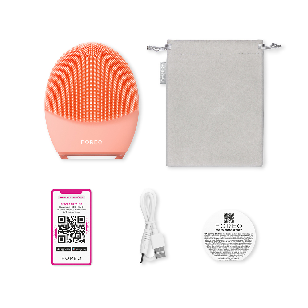 A peach-colored Foreo facial brush with accessories and a gray pouch.