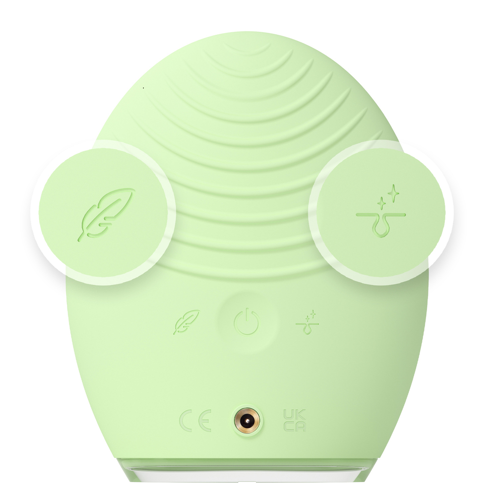 Achterkant van het groene FOREO-apparaat. Met pictogrammen en oplaadpoort.