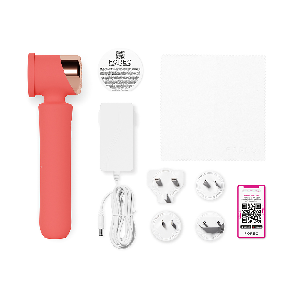 A set of FOREO products: a coral device, charger, plugs, and a cleaning cloth.