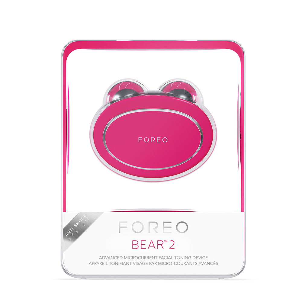 A pink Foreo Bear 2 device in a clear box. The device has a bear shape.
