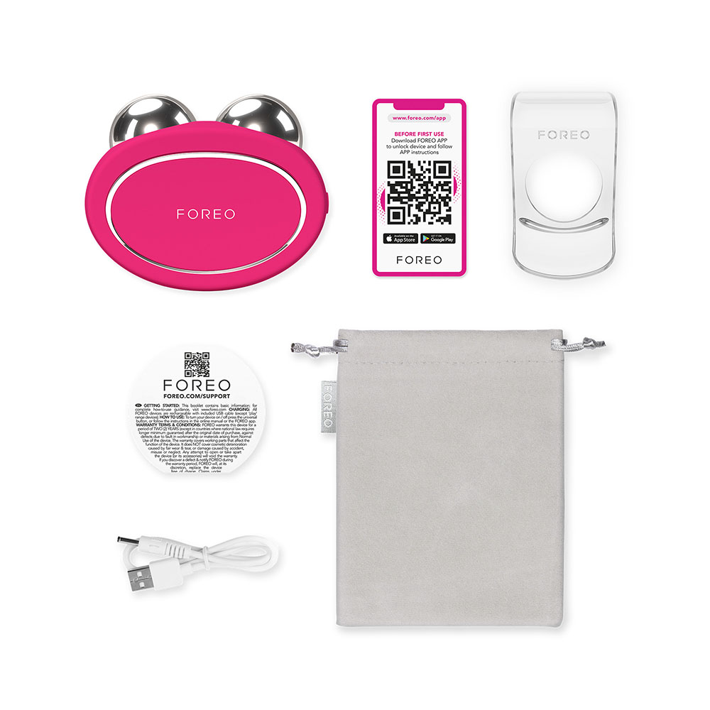 Pink FOREO device, app instructions, charging cable, soft pouch and other accessories are shown.