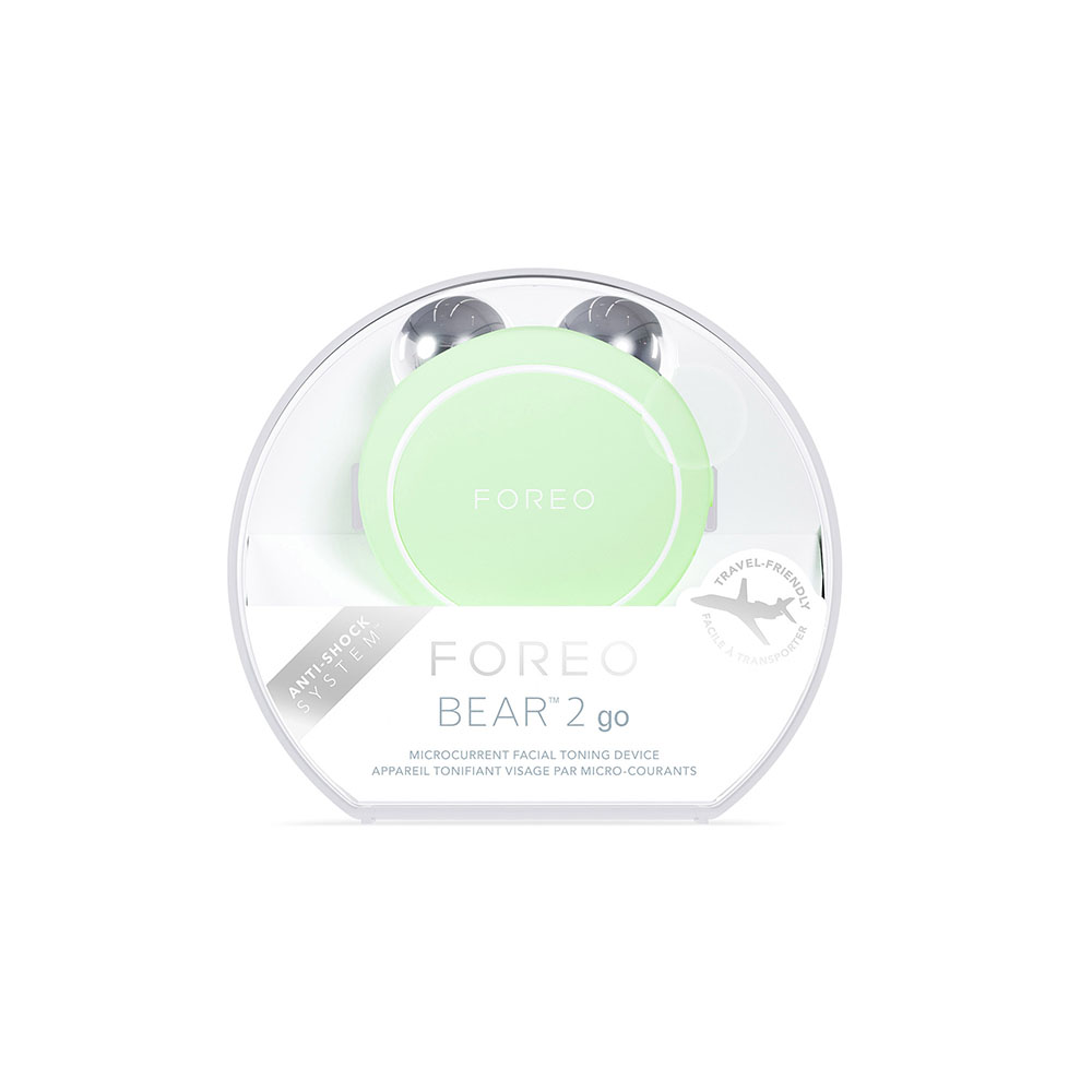 A Foreo Bear 2 go device in packaging, with a travel-friendly design, on a white background.