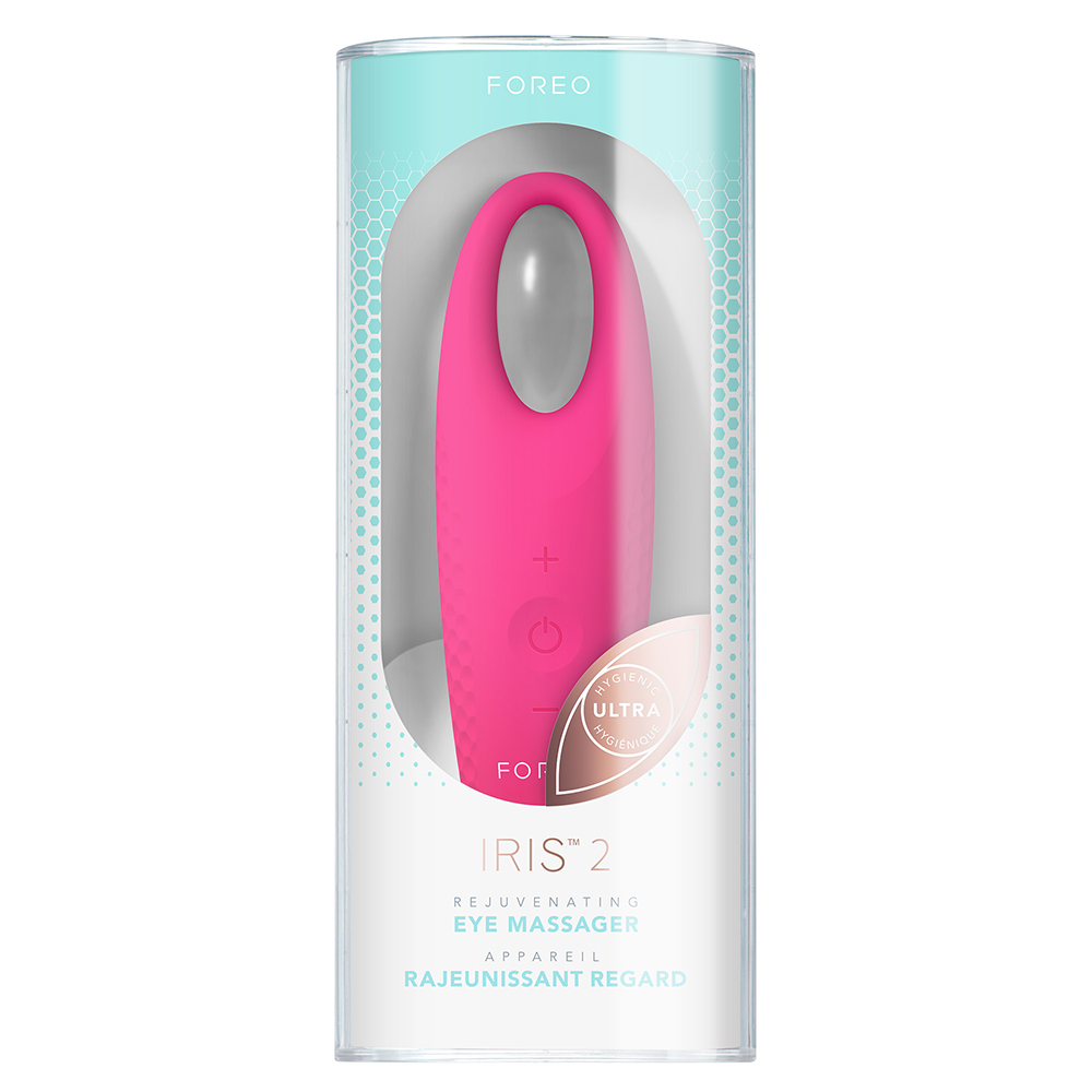 Un masseur oculaire Foreo Iris 2 rose dans un tube transparent. L'appareil a des boutons.