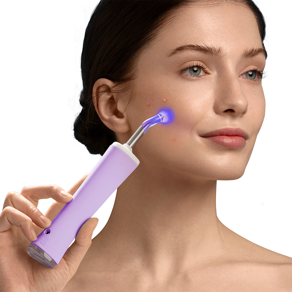 Woman using a purple skin treatment device on her face. Blue light emanates from device tip. White background.