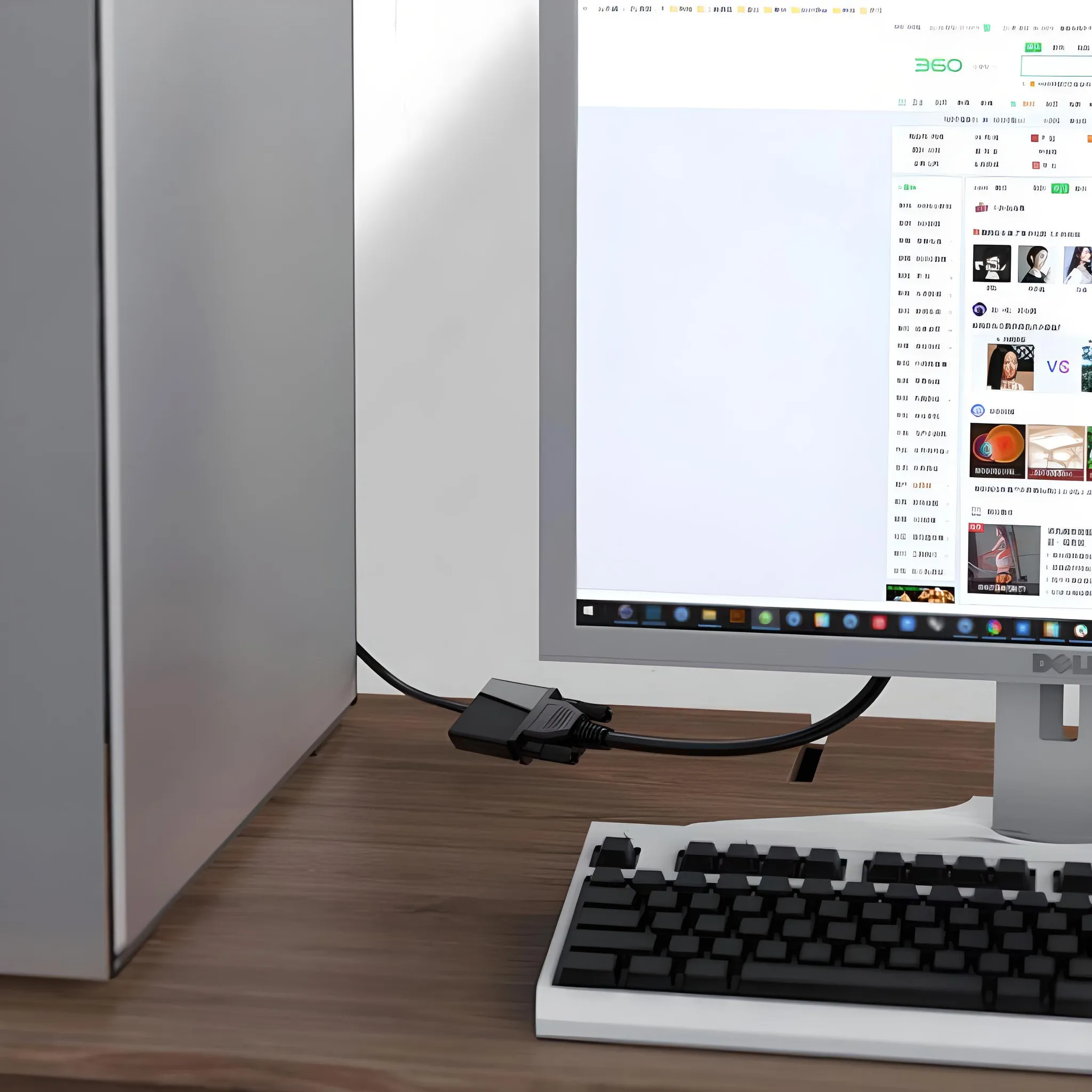 Computer-Setup mit Monitor, Tastatur und einem VGA-Kabel, das an der Rückseite angeschlossen ist.