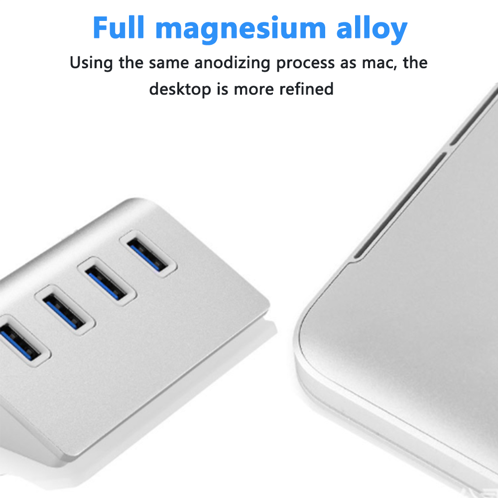 Silberner USB-Hub mit vier Anschlüssen und einer Laptopkante. Text: Vollmagnesiumlegierung, verfeinerter Desktop.