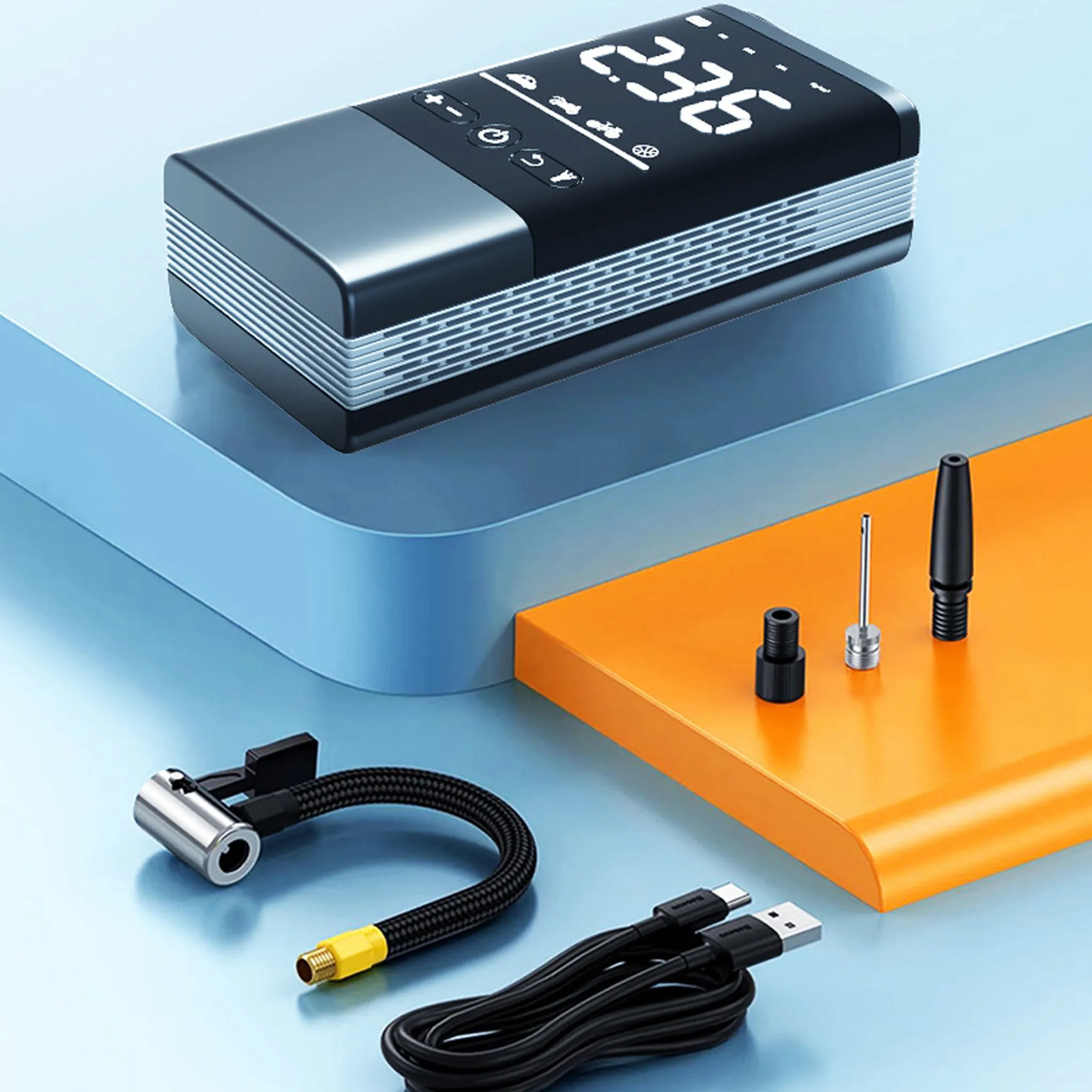 Ein schwarzer und grauer Reifenfüller mit Zubehör. Er hat ein digitales Display und ein USB-C-Kabel.
