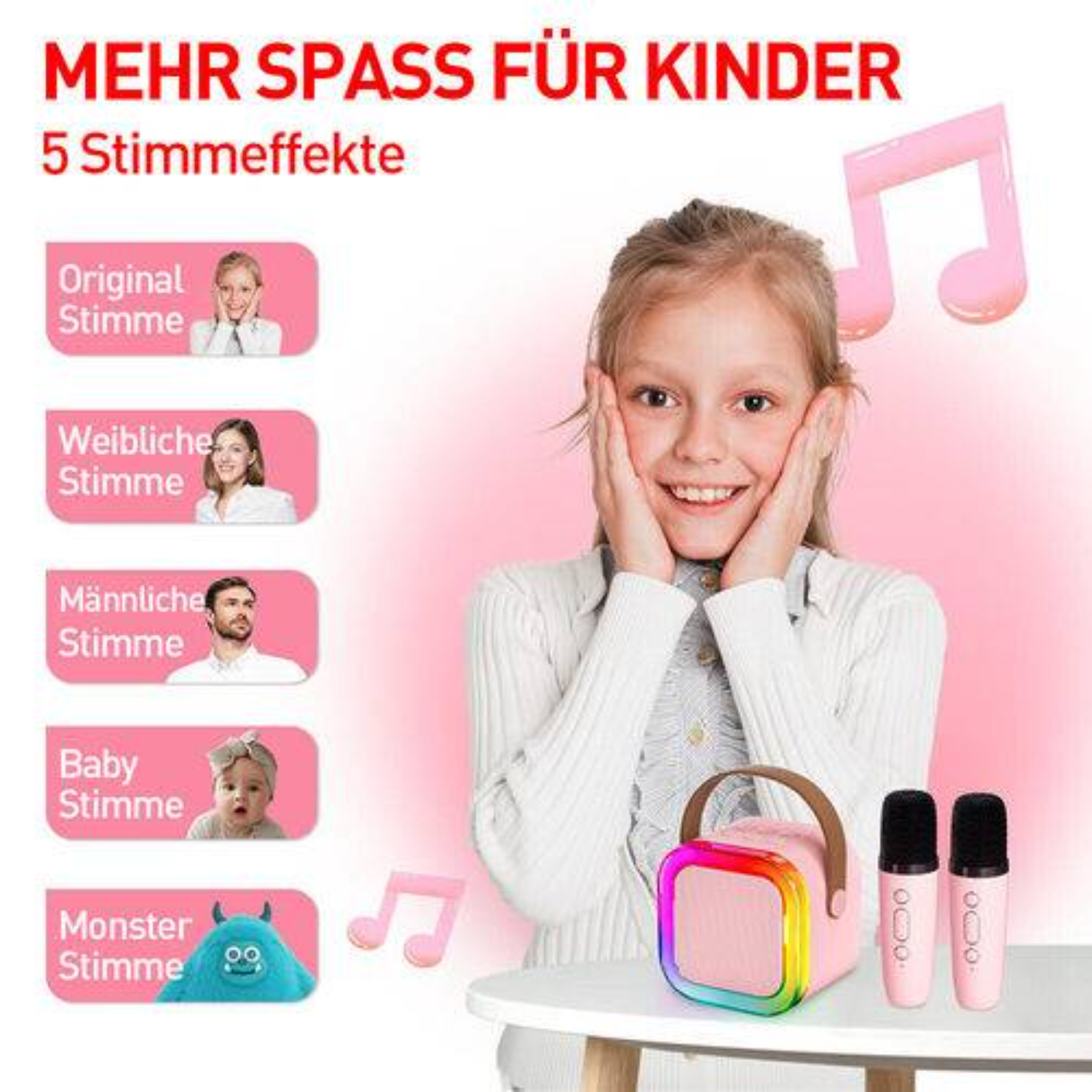 Ein junges Mädchen lächelt in die Kamera, mit einem rosa Lautsprecher und zwei Mikrofonen auf einem Tisch neben ihr.