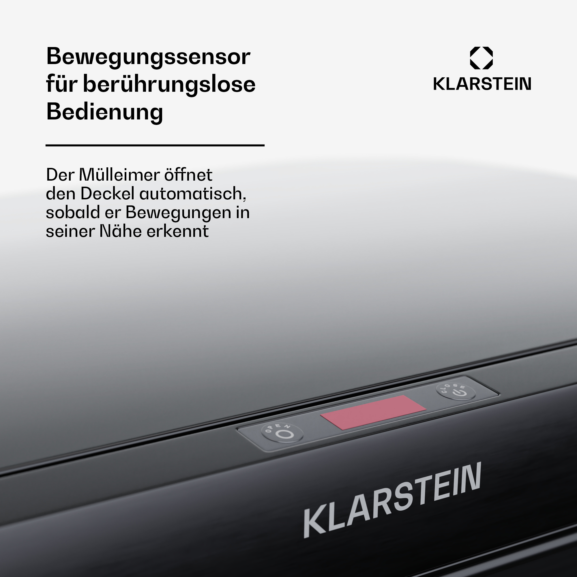 Nahaufnahme eines schwarzen Mülleimerdeckels mit Bedienfeld. Der Text lautet 'Berührungslose Bedienung'.